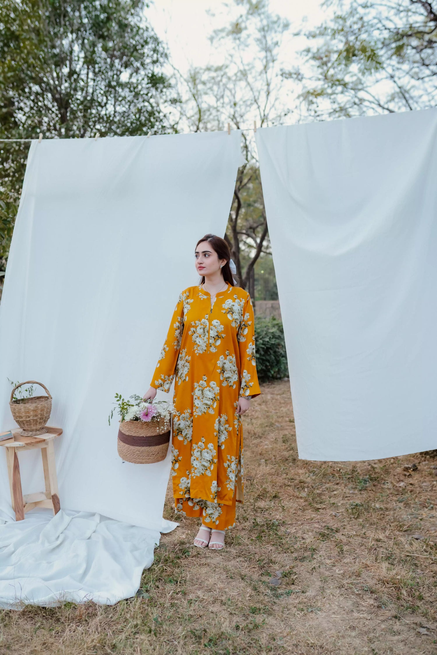 Yellow floral two-piece suit with long shirt and flared pants, styled for casual and semi-formal occasions.