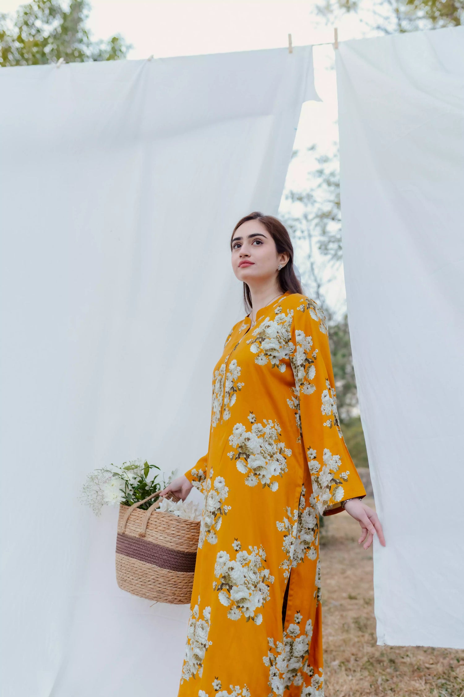Yellow floral two-piece suit with long shirt and flared pants, styled for casual and semi-formal occasions.