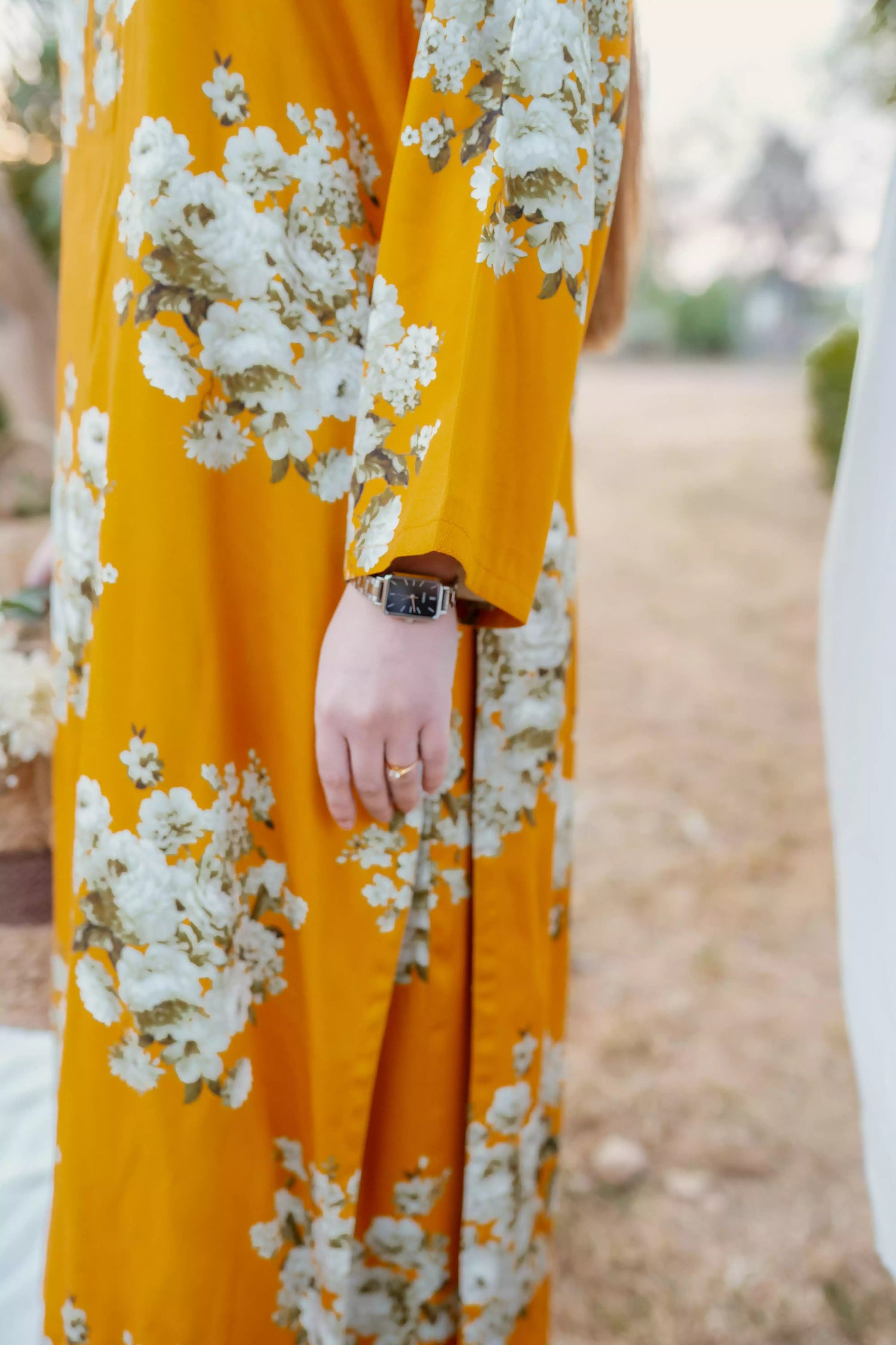 Yellow floral two-piece suit with long shirt and flared pants, styled for casual and semi-formal occasions.