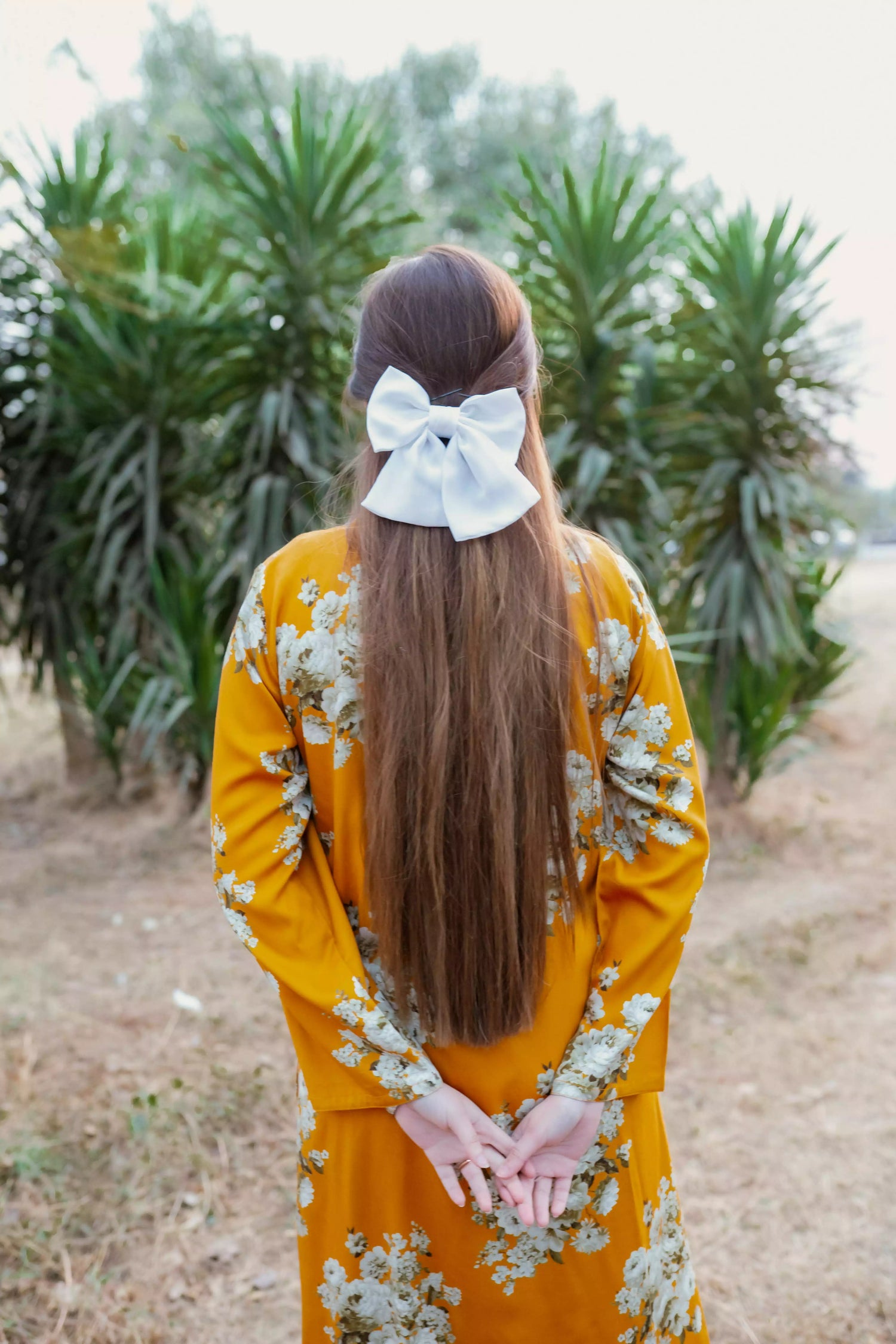 Yellow floral two-piece suit with long shirt and flared pants, styled for casual and semi-formal occasions.