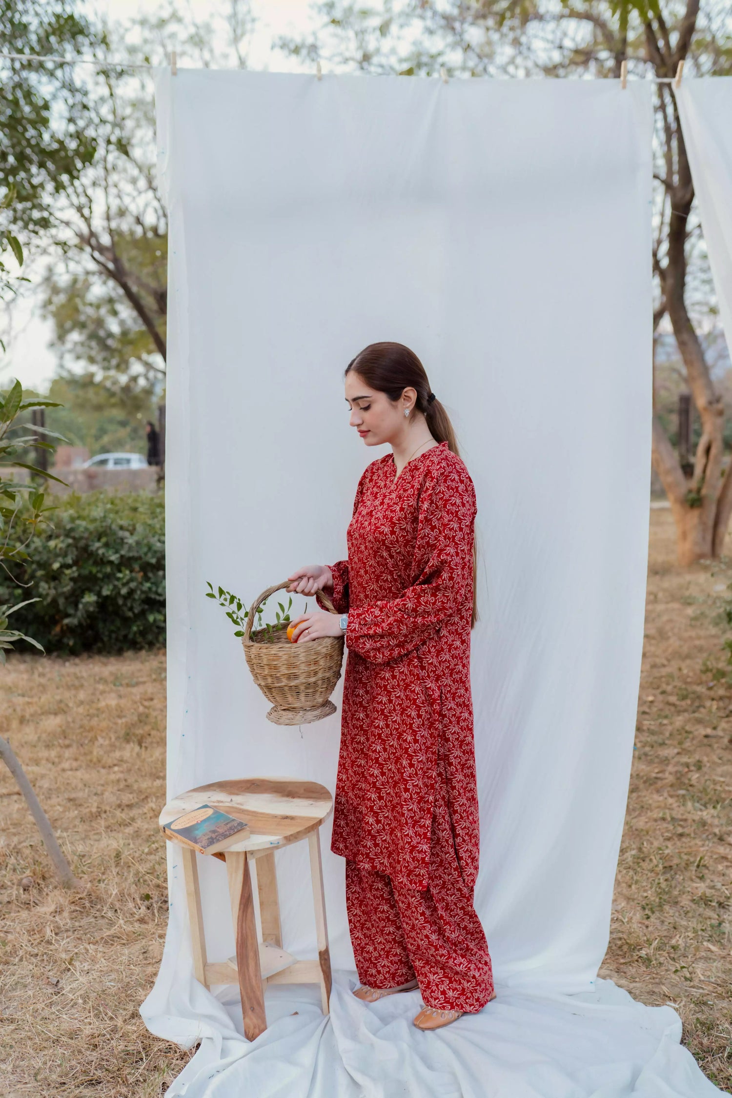 Chic maroon ensemble with bold floral design and puff sleeves, paired with loose-fit shalwar.