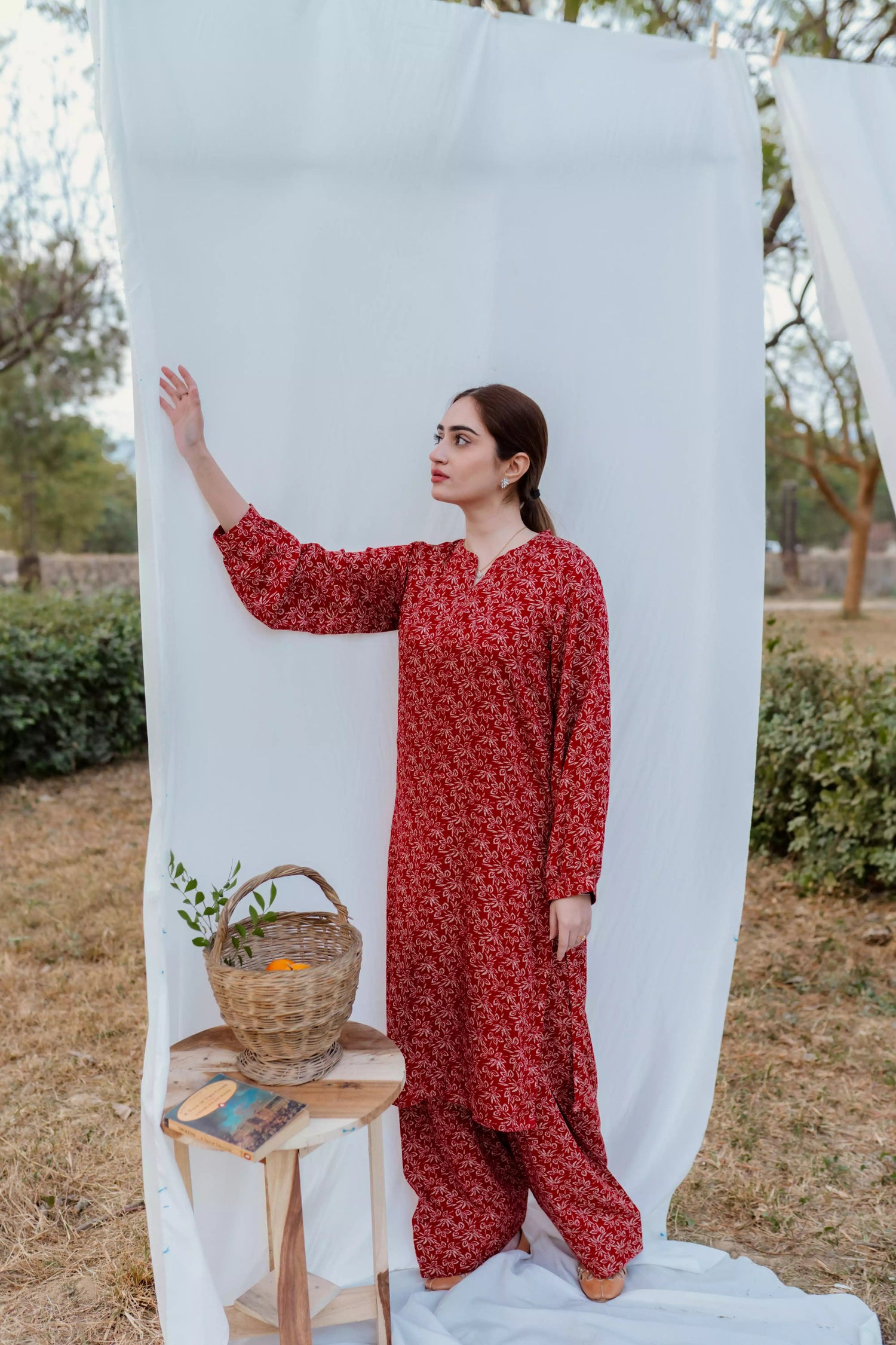 Chic maroon ensemble with bold floral design and puff sleeves, paired with loose-fit shalwar.
