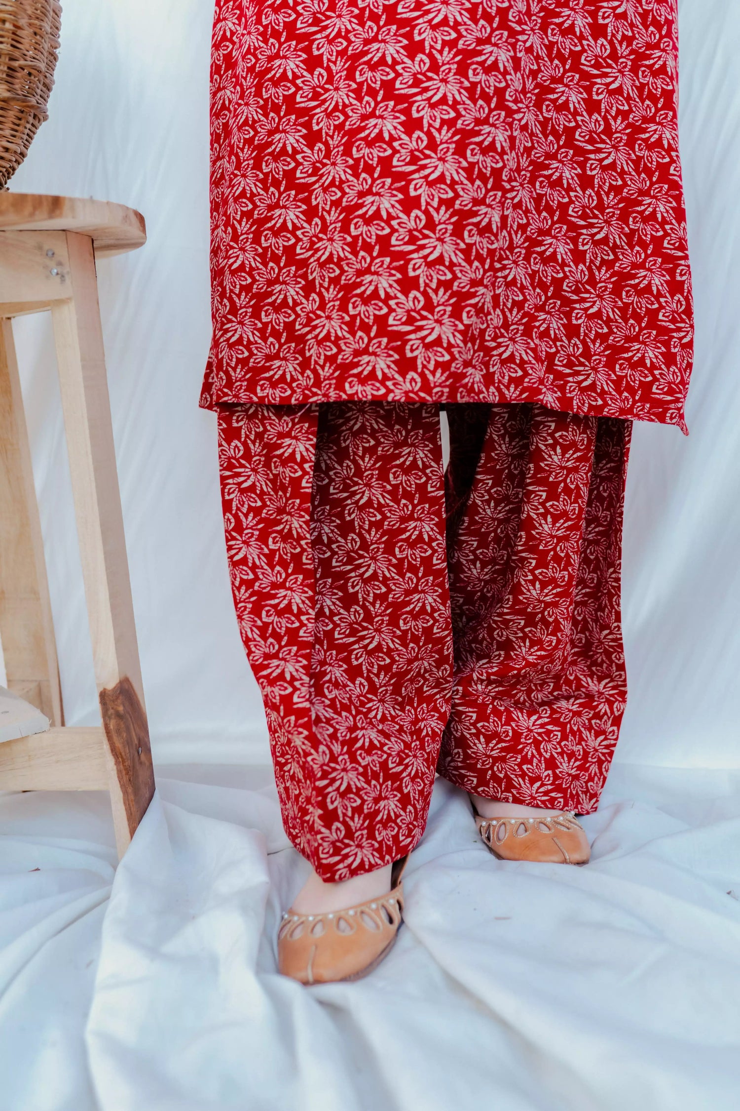 Chic maroon ensemble with bold floral design and puff sleeves, paired with loose-fit shalwar.