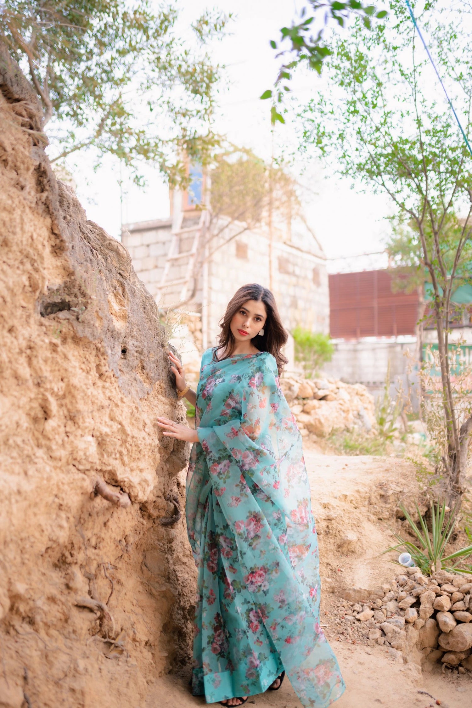 A vibrant floral saree complemented by a matching blouse and a graceful petticoat for a chic look.