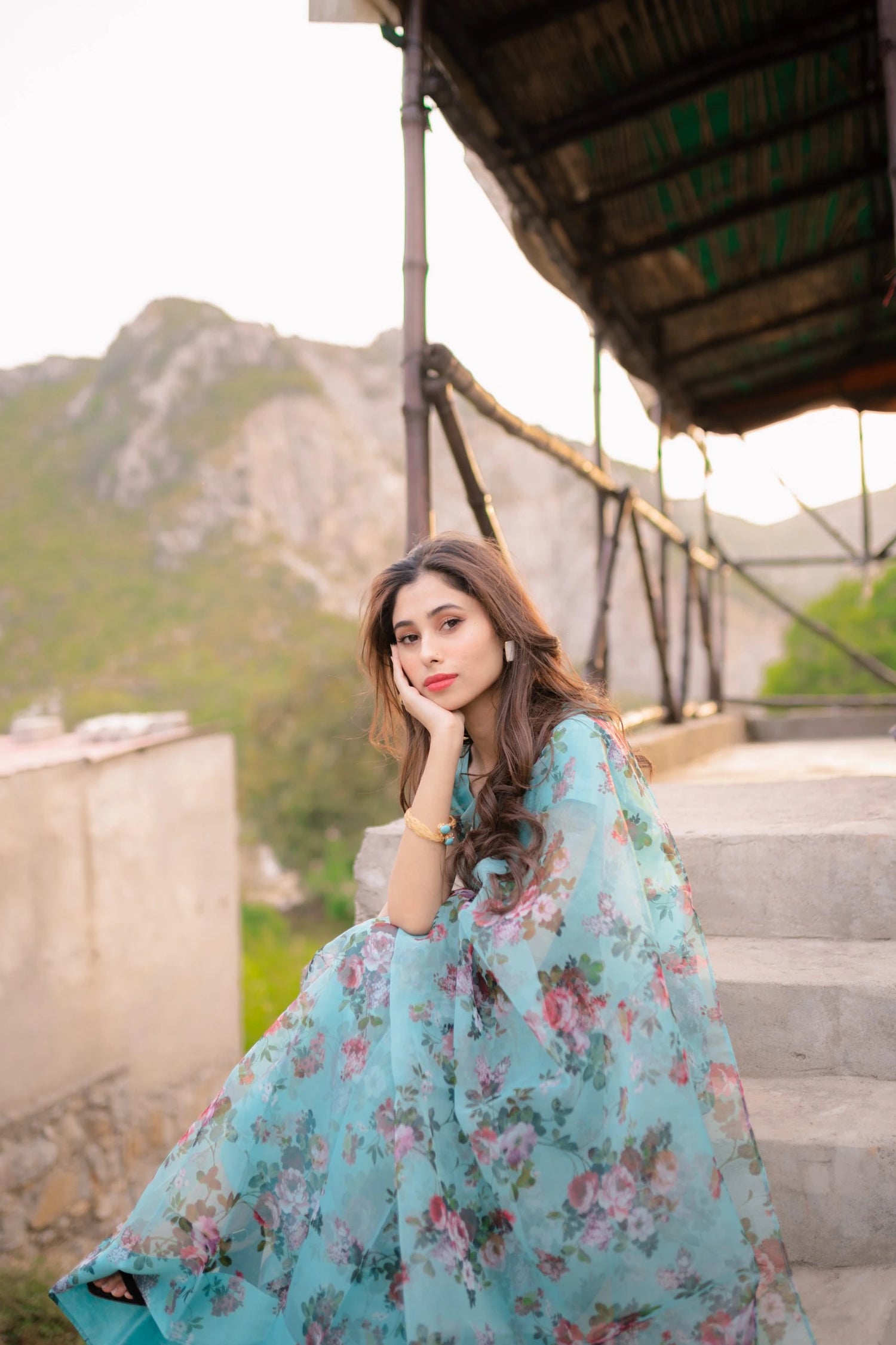 A vibrant floral saree complemented by a matching blouse and a graceful petticoat for a chic look.