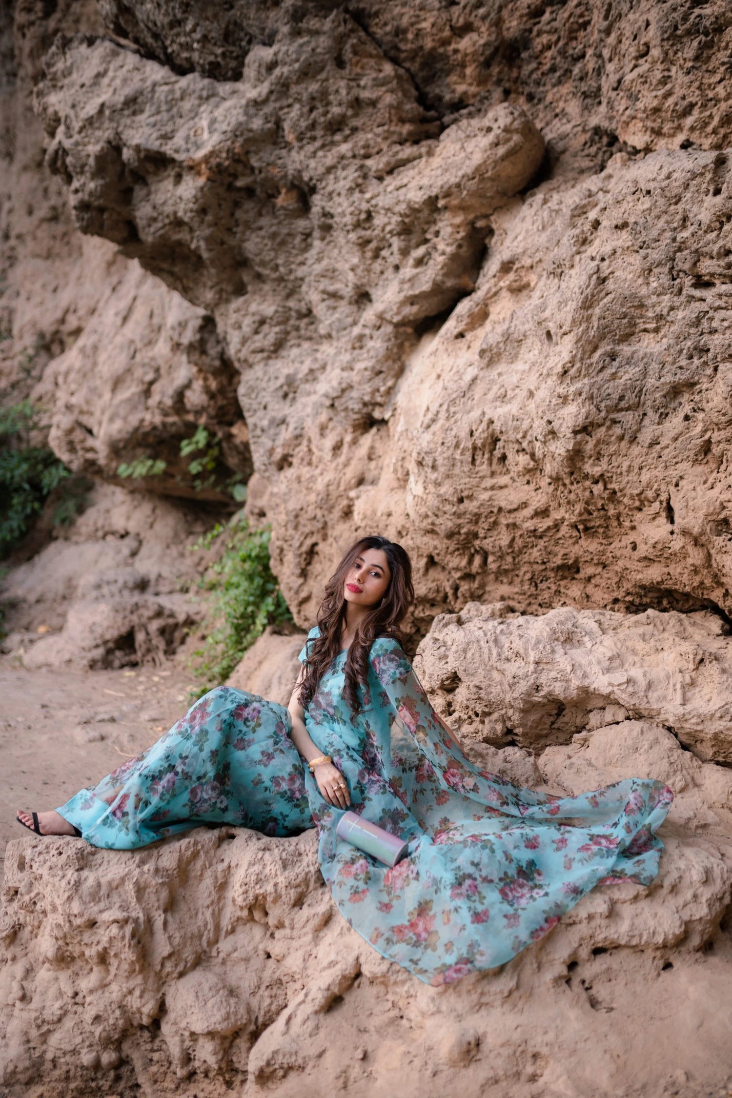 A vibrant floral saree complemented by a matching blouse and a graceful petticoat for a chic look.