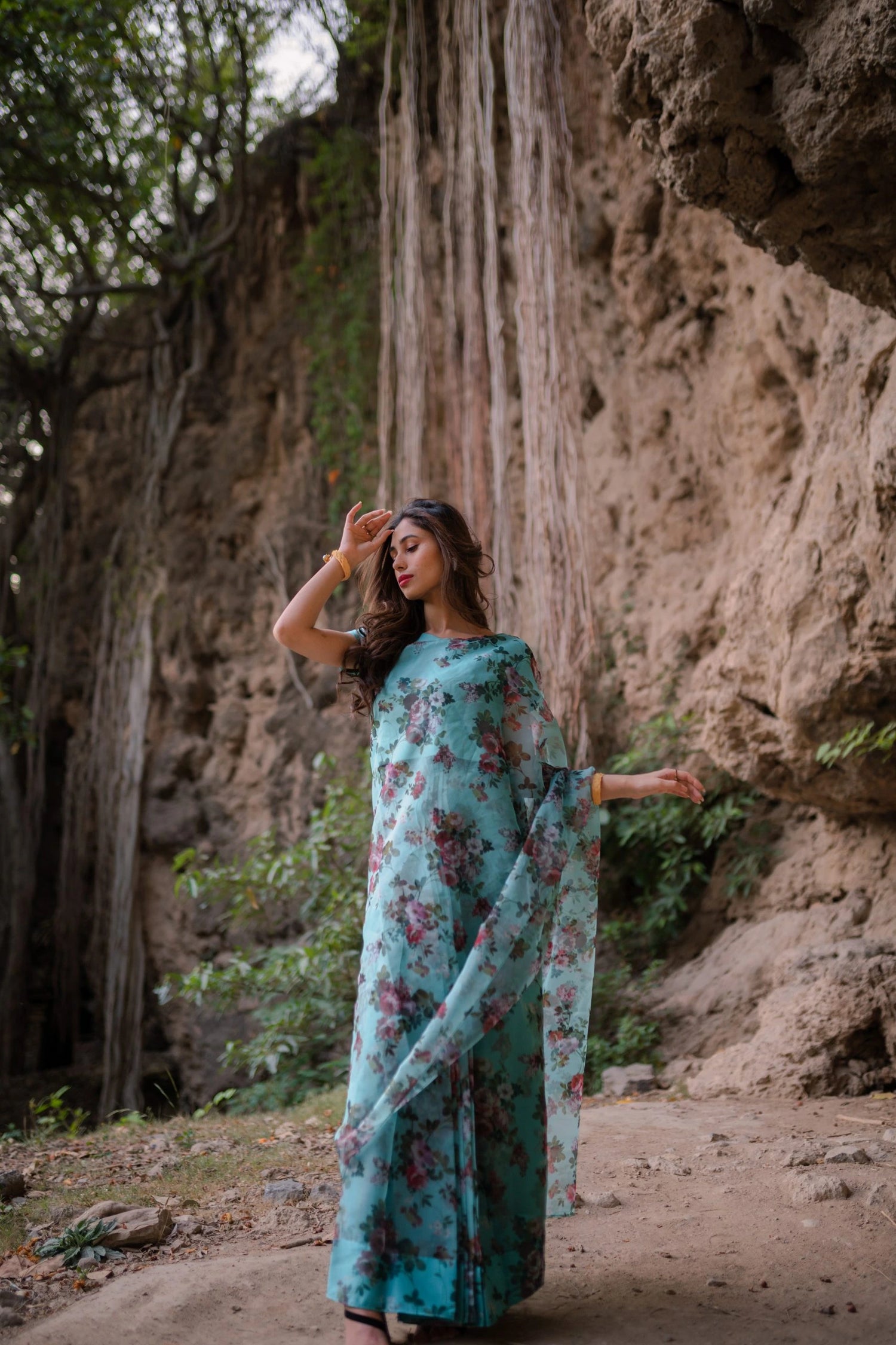 A vibrant floral saree complemented by a matching blouse and a graceful petticoat for a chic look.