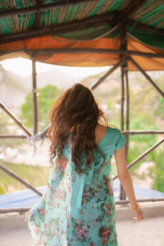 A vibrant floral saree complemented by a matching blouse and a graceful petticoat for a chic look.