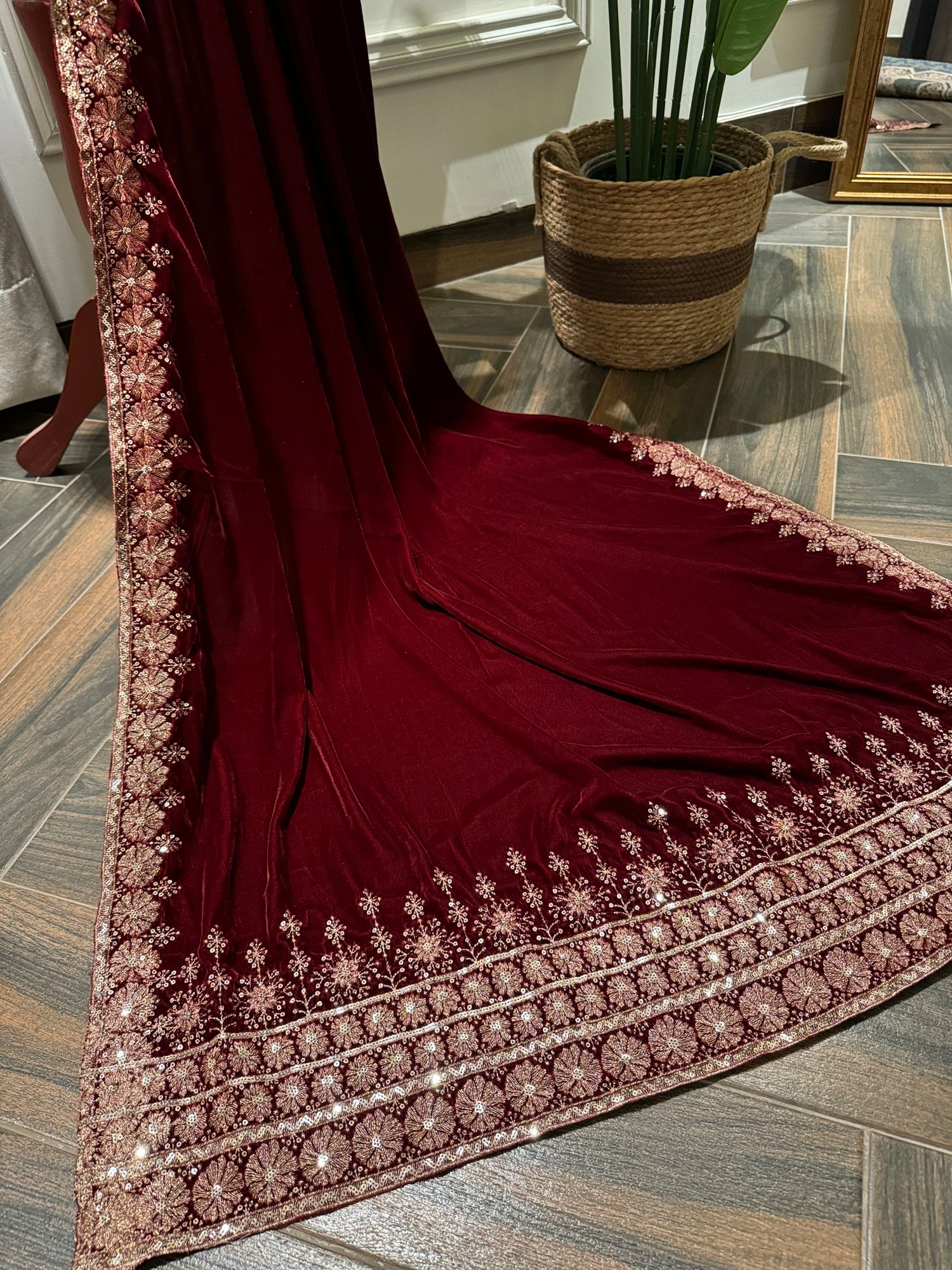 Exquisite deep maroon velvet shawl with wide antique gold tilla embroidery and sequins forming intricate floral motifs along scalloped edges, perfect for formal winter occasions.