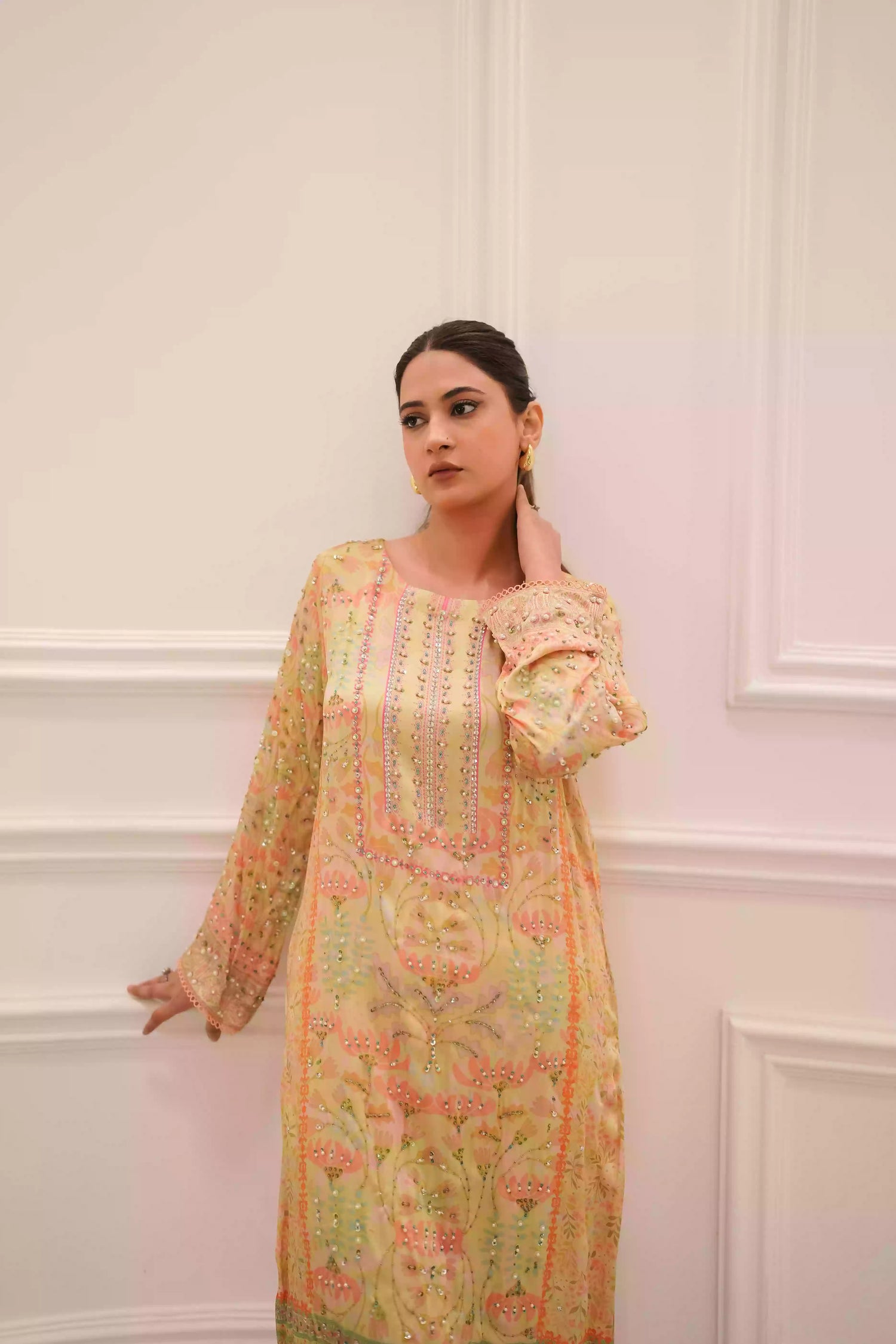 Lime yellow silk kurta in a soft pastel tone, featuring intricate floral embellishment on full-length sleeves, and a relaxed elegant silhouette, designed for festive eid gatherings, daytime celebrations, and refined evening wear.