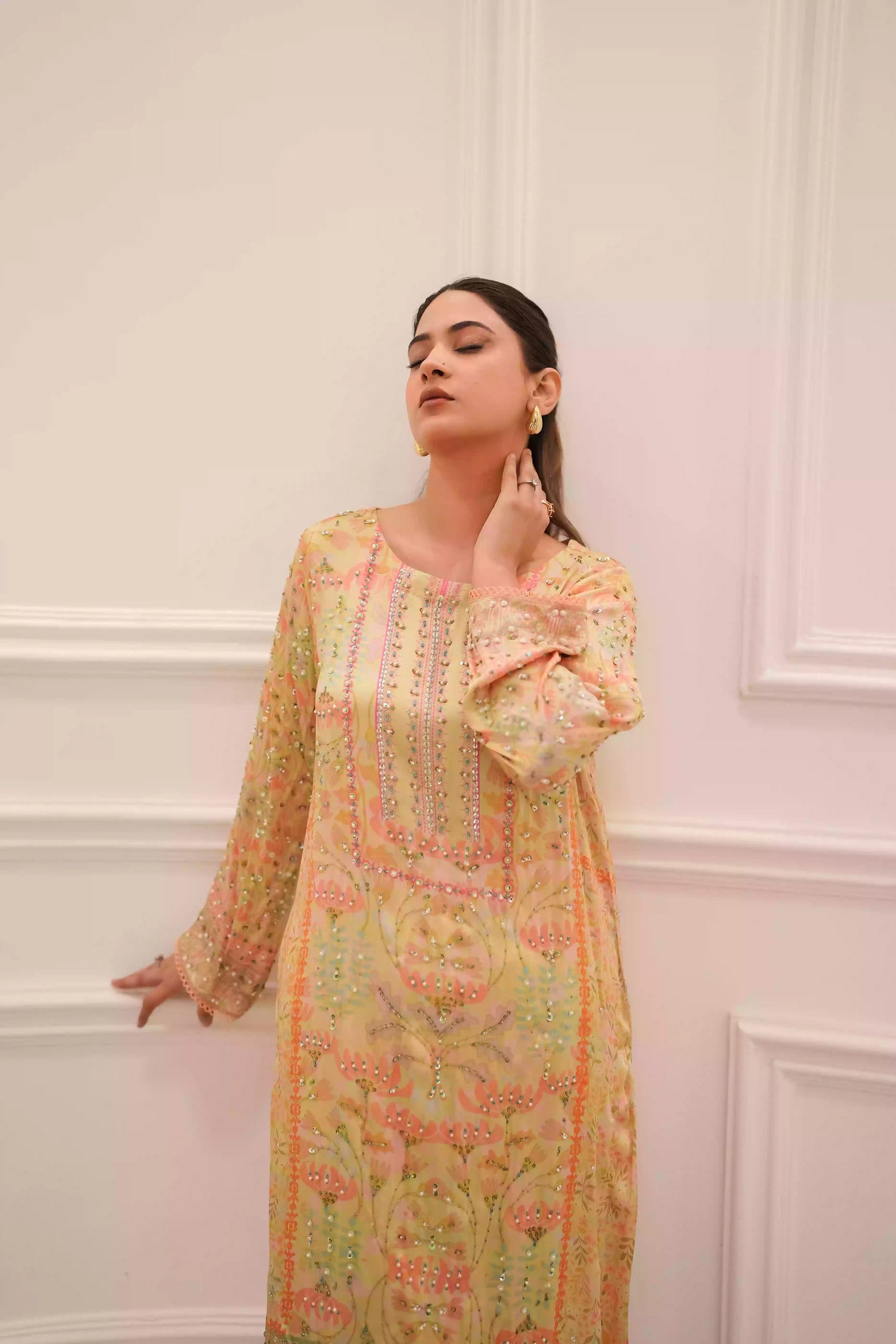 Lime yellow silk kurta in a soft pastel tone, featuring intricate floral embellishment on full-length sleeves, and a relaxed elegant silhouette, designed for festive eid gatherings, daytime celebrations, and refined evening wear.