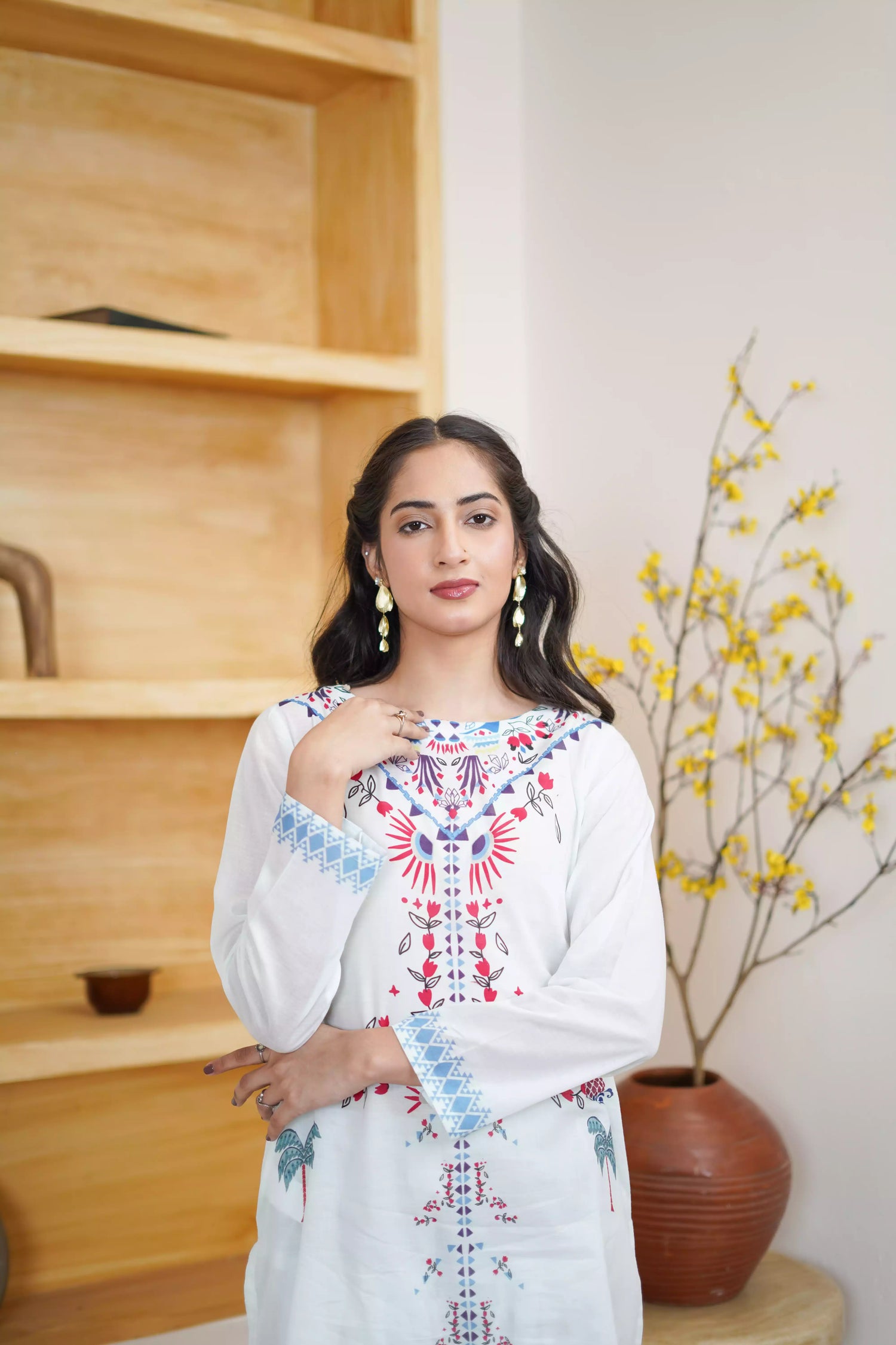White floral dress featuring detailed  intricate floral and bird designs, a blend of elegance and nature.