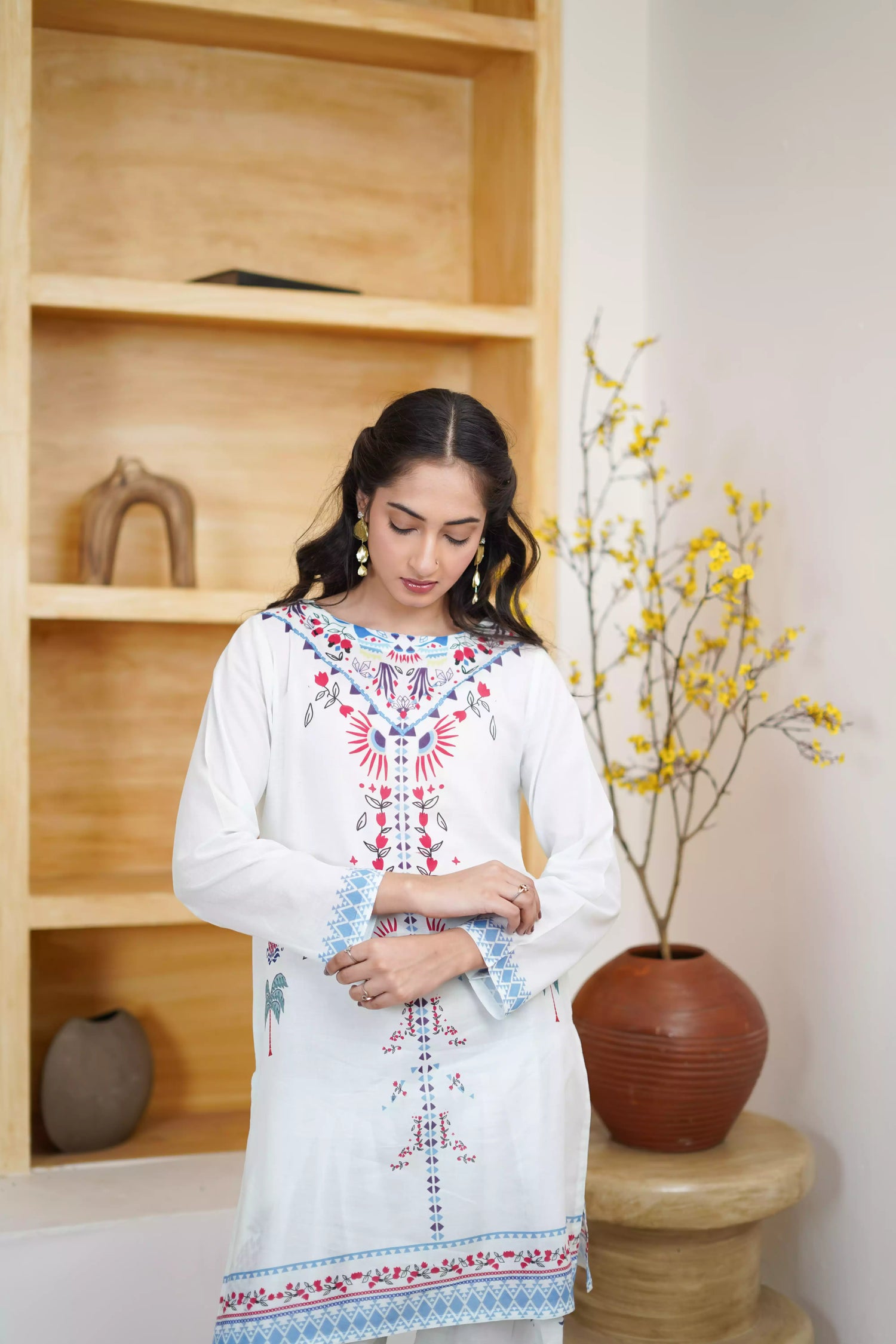 White floral dress featuring detailed  intricate floral and bird designs, a blend of elegance and nature.