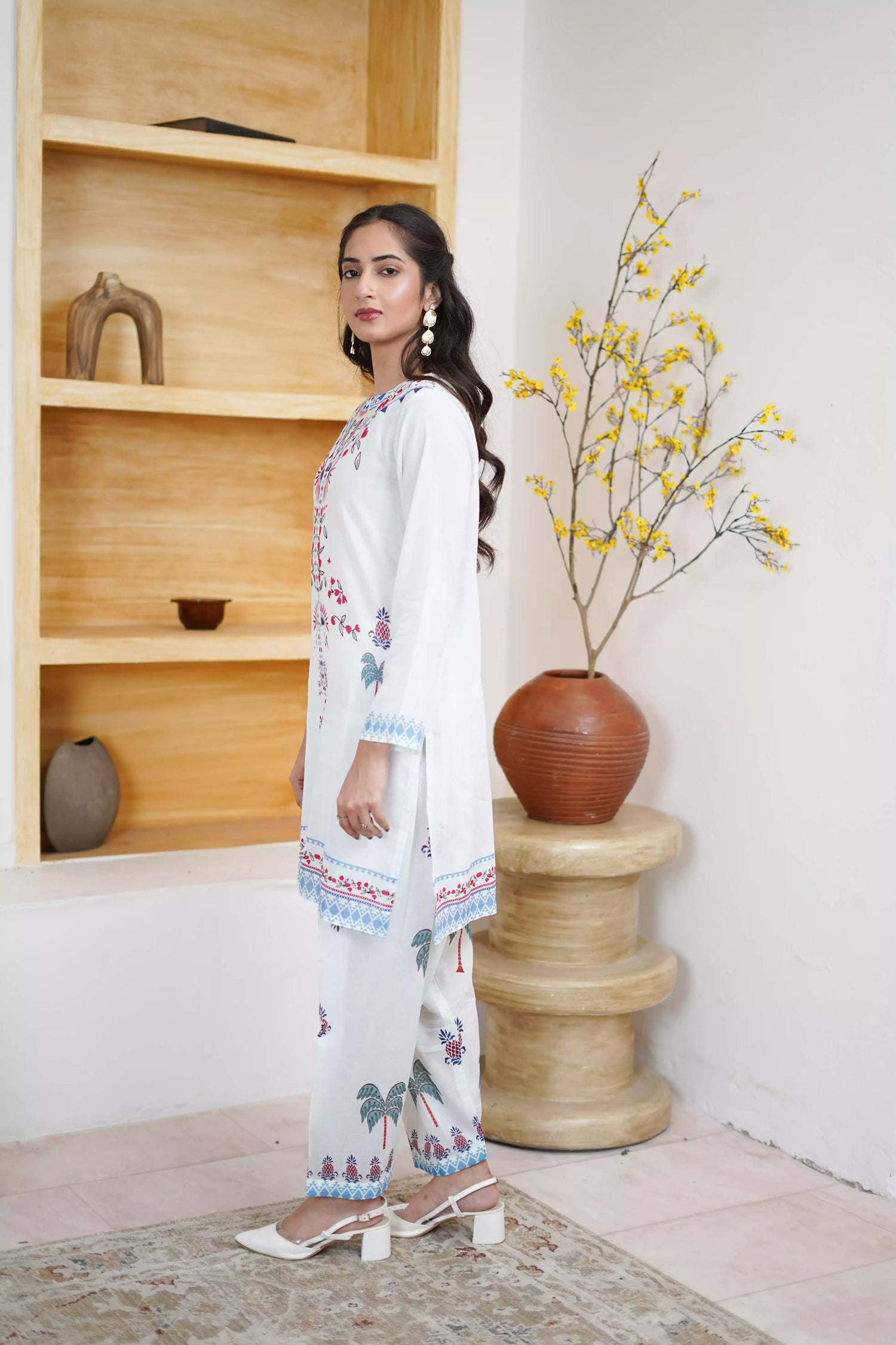 White floral dress featuring detailed  intricate floral and bird designs, a blend of elegance and nature.