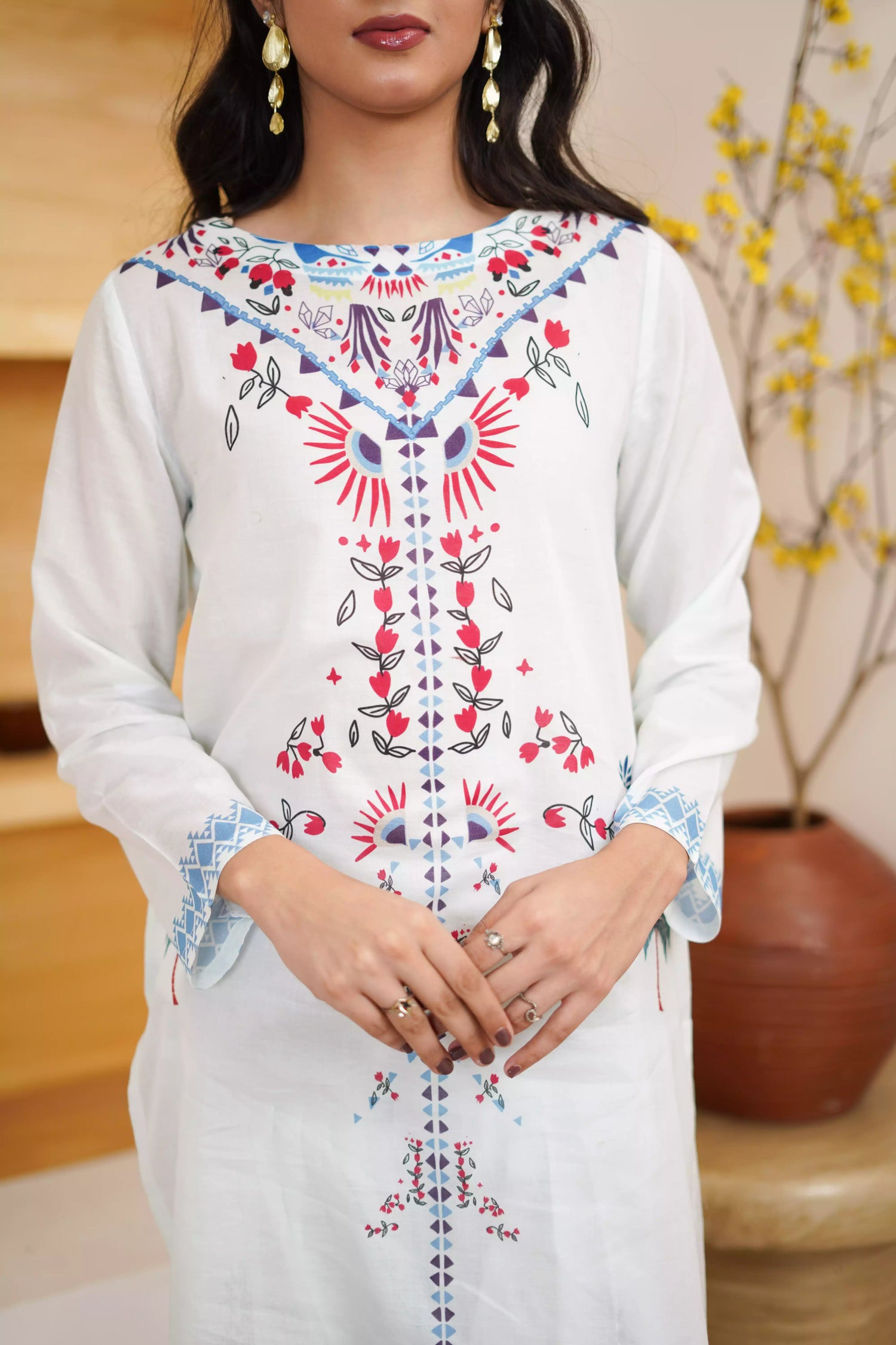 White floral dress featuring detailed  intricate floral and bird designs, a blend of elegance and nature.