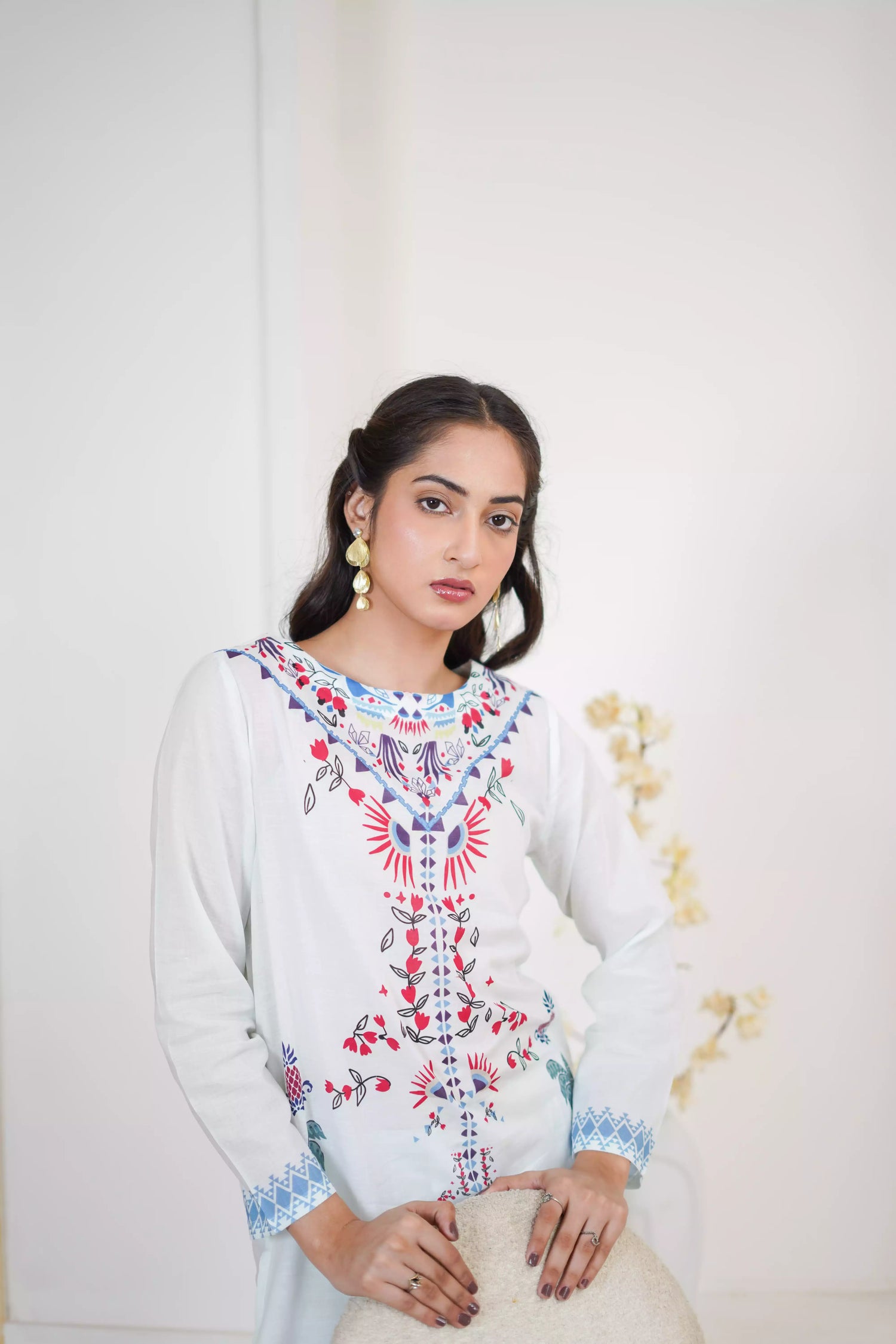 White floral dress featuring detailed  intricate floral and bird designs, a blend of elegance and nature.