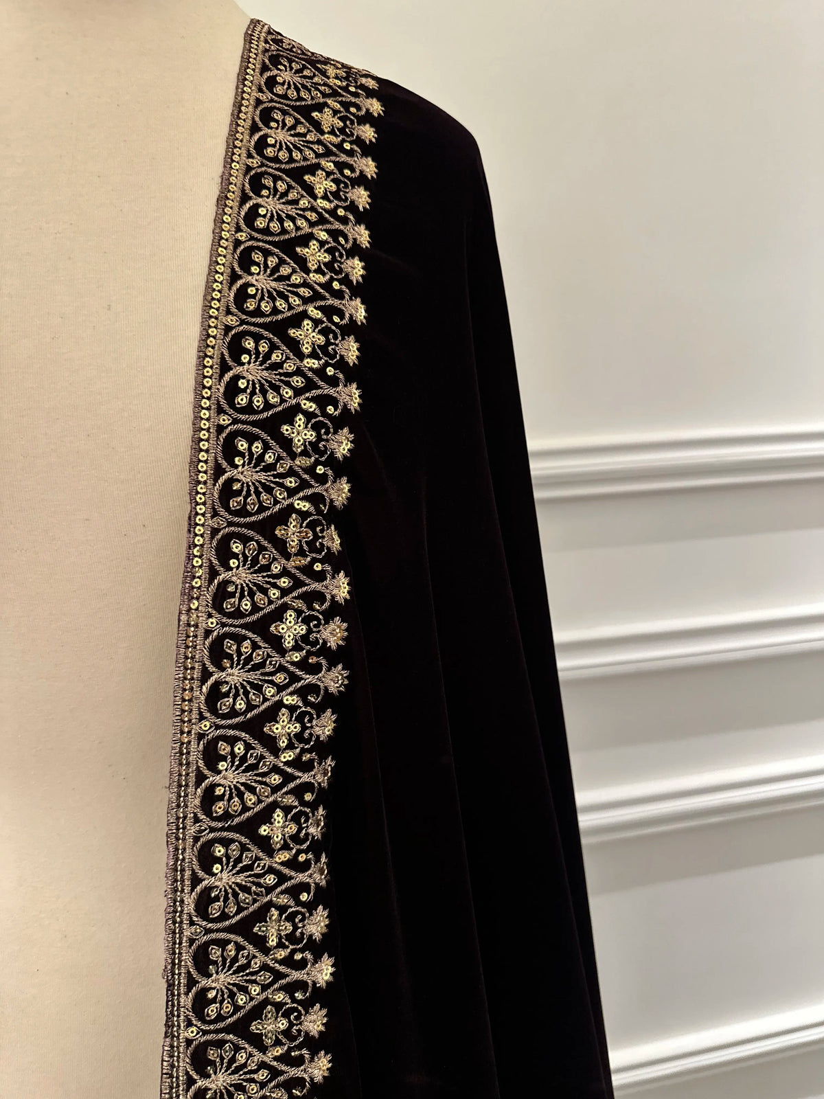 Elegant black velvet shawl with heavy gold tilla border and intricate gold floral embroidery, perfect for weddings, Eid, or festive occasions.