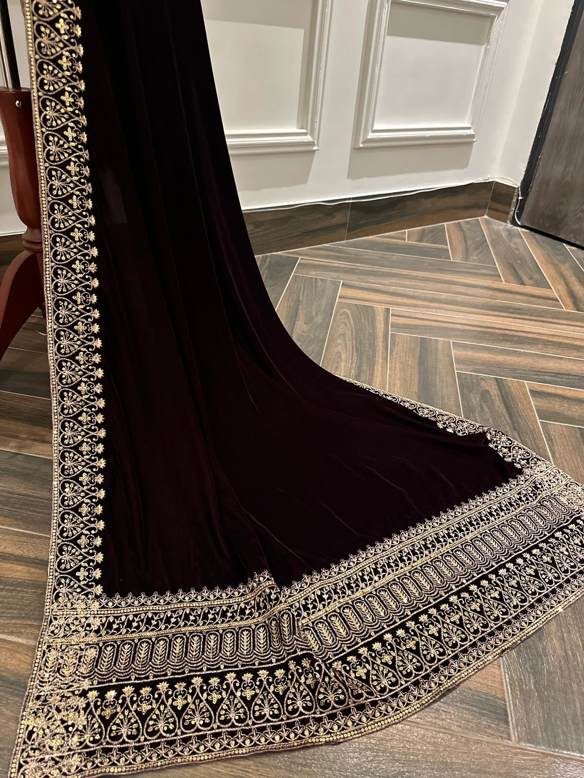 Elegant black velvet shawl with heavy gold tilla border and intricate gold floral embroidery, perfect for weddings, Eid, or festive occasions.
