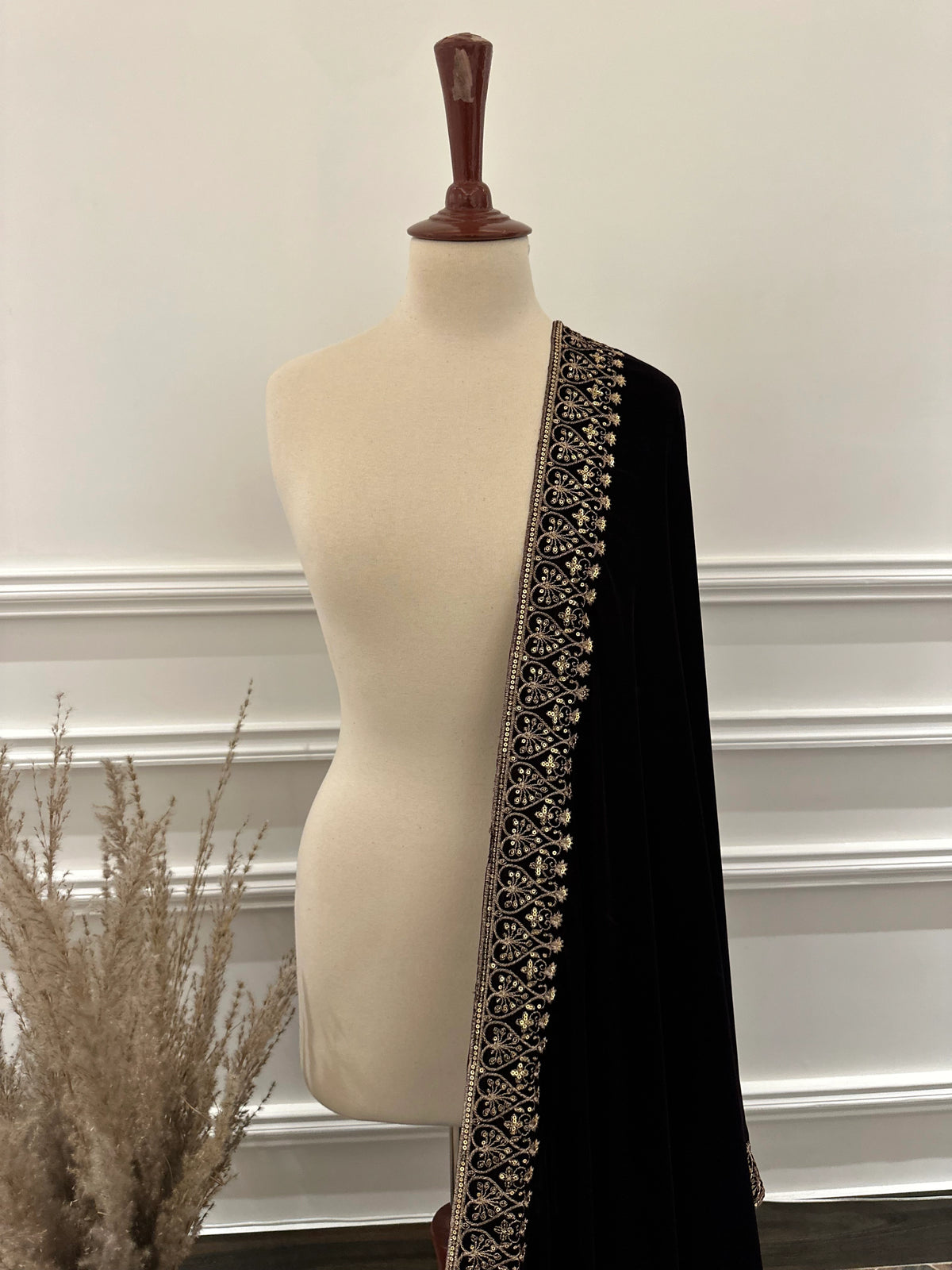 Elegant black velvet shawl with heavy gold tilla border and intricate gold floral embroidery, perfect for weddings, Eid, or festive occasions.