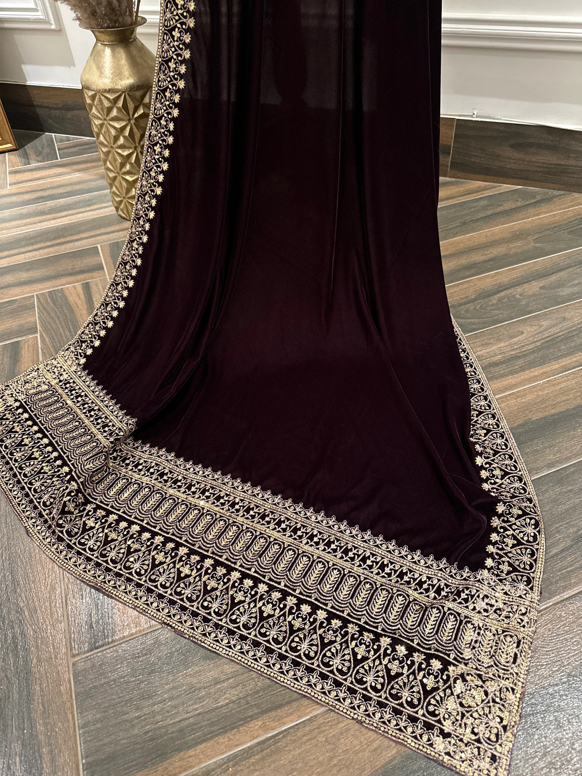 Elegant black velvet shawl with heavy gold tilla border and intricate gold floral embroidery, perfect for weddings, Eid, or festive occasions.
