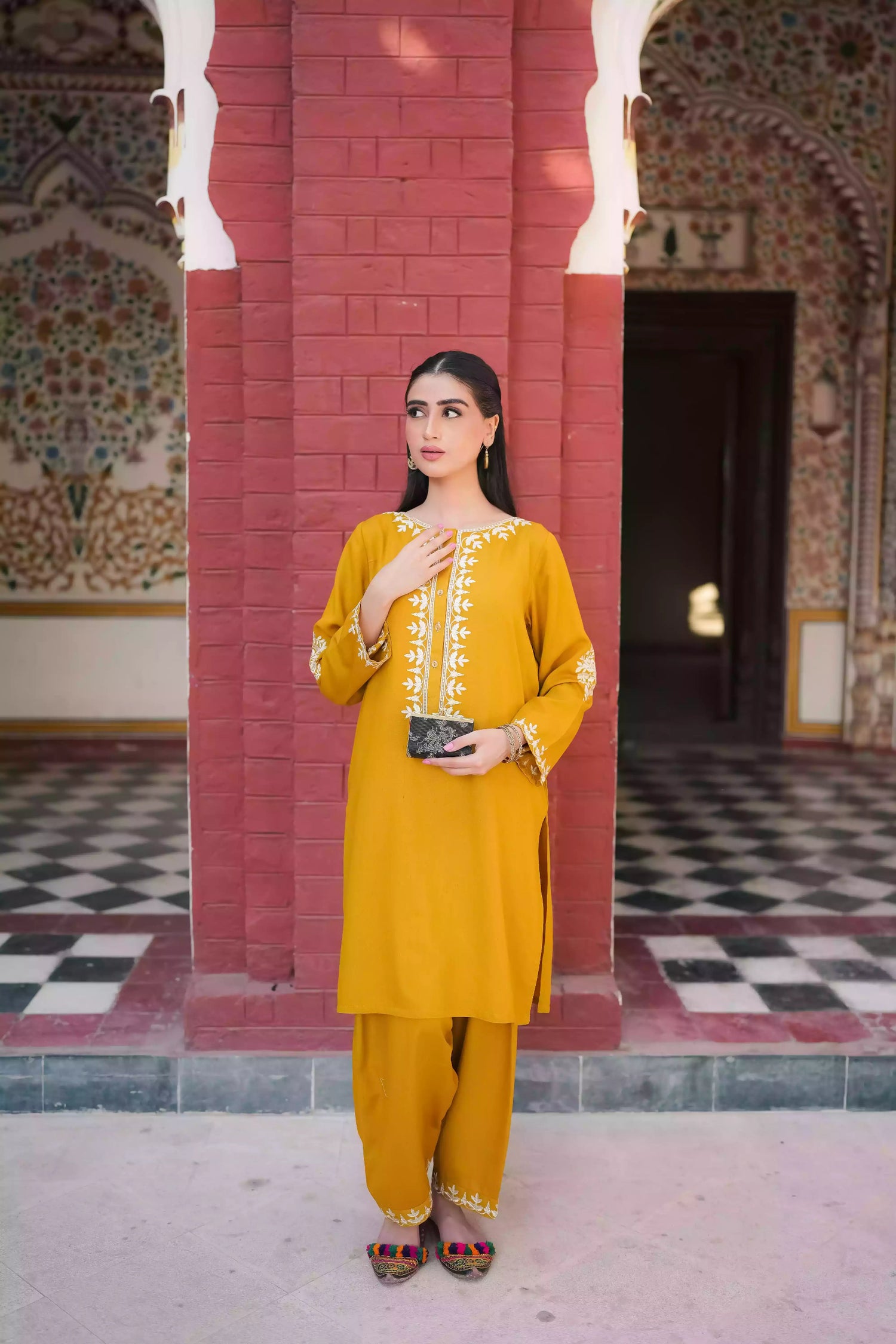 Mustard yellow embroidered kurta, featuring soft, flowing fabric with delicate white floral embroidery paired with a shalwar detailed with subtle threadwork. Styled for modern, festive, or daytime wear.