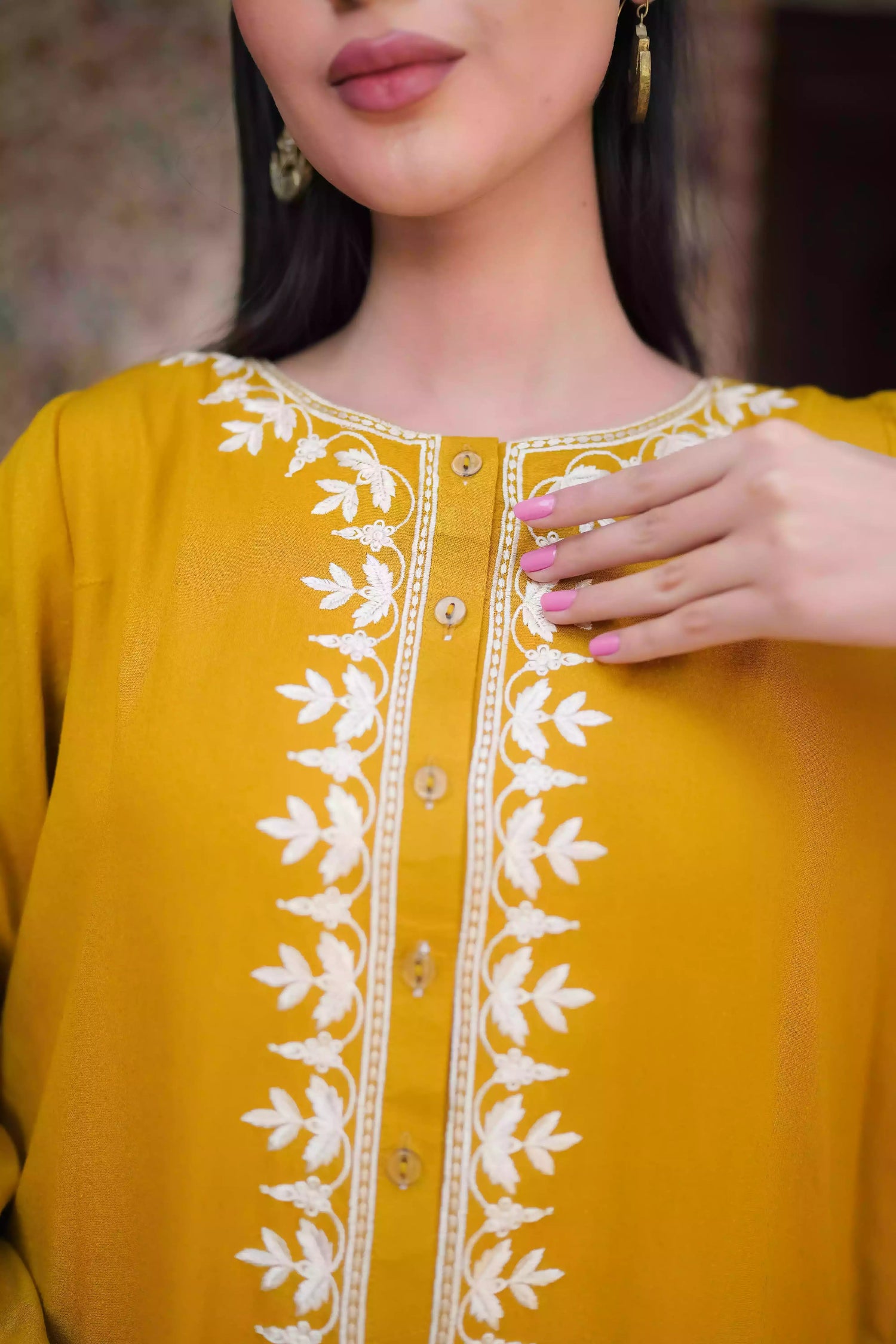Mustard yellow embroidered kurta, featuring soft, flowing fabric with delicate white floral embroidery paired with a shalwar detailed with subtle threadwork. Styled for modern, festive, or daytime wear.