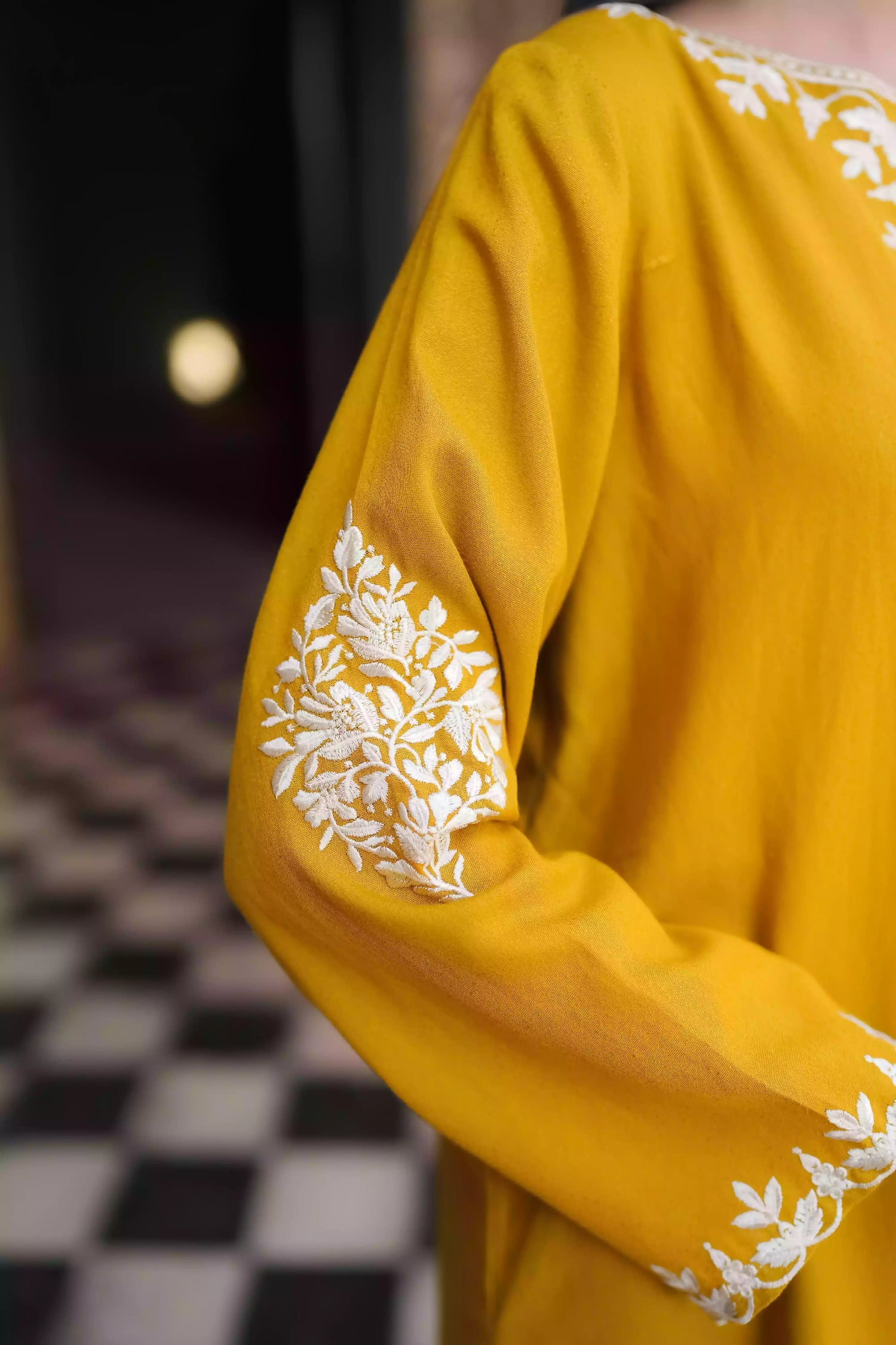 Mustard yellow embroidered kurta, featuring soft, flowing fabric with delicate white floral embroidery paired with a shalwar detailed with subtle threadwork. Styled for modern, festive, or daytime wear.