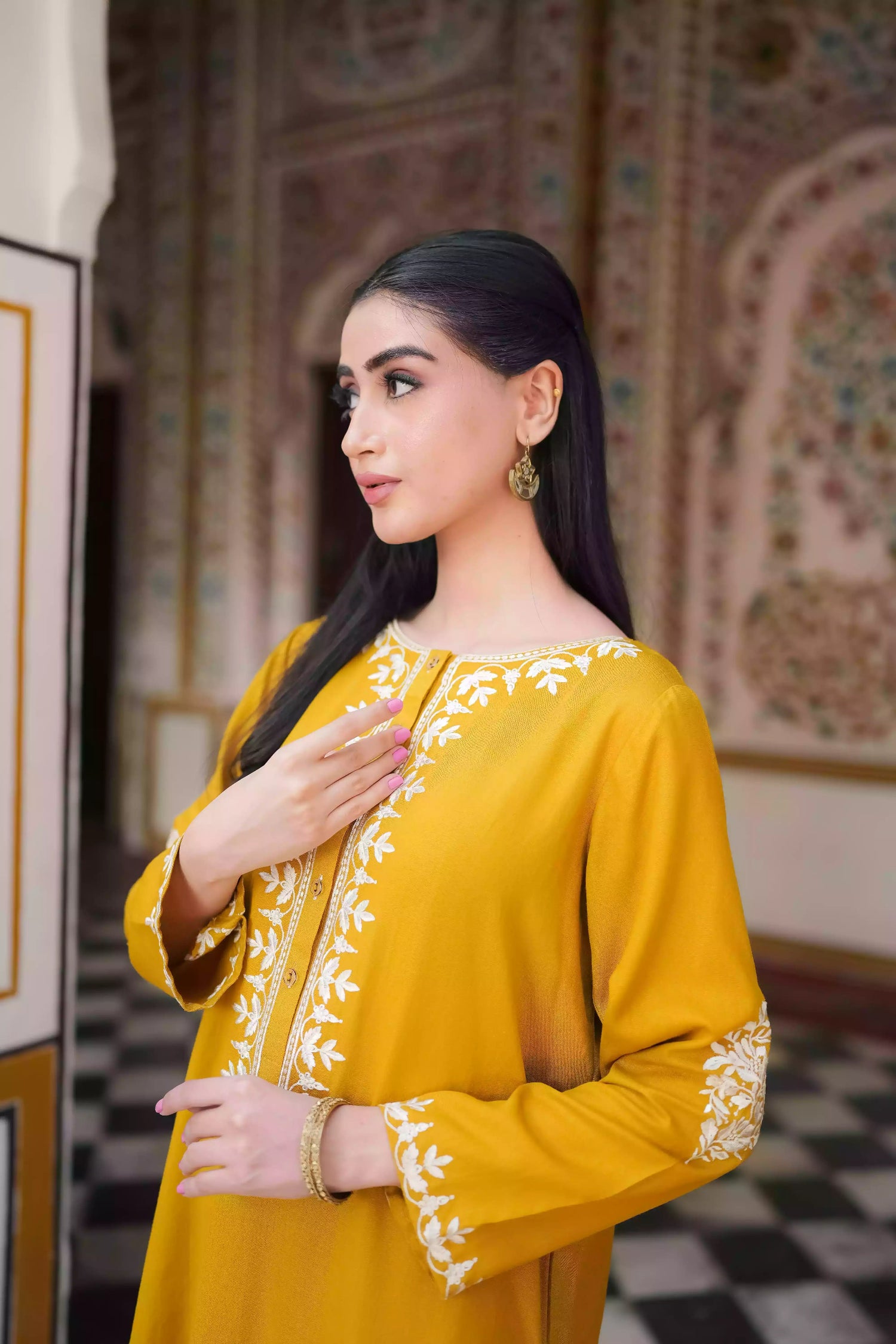 Mustard yellow embroidered kurta, featuring soft, flowing fabric with delicate white floral embroidery paired with a shalwar detailed with subtle threadwork. Styled for modern, festive, or daytime wear.