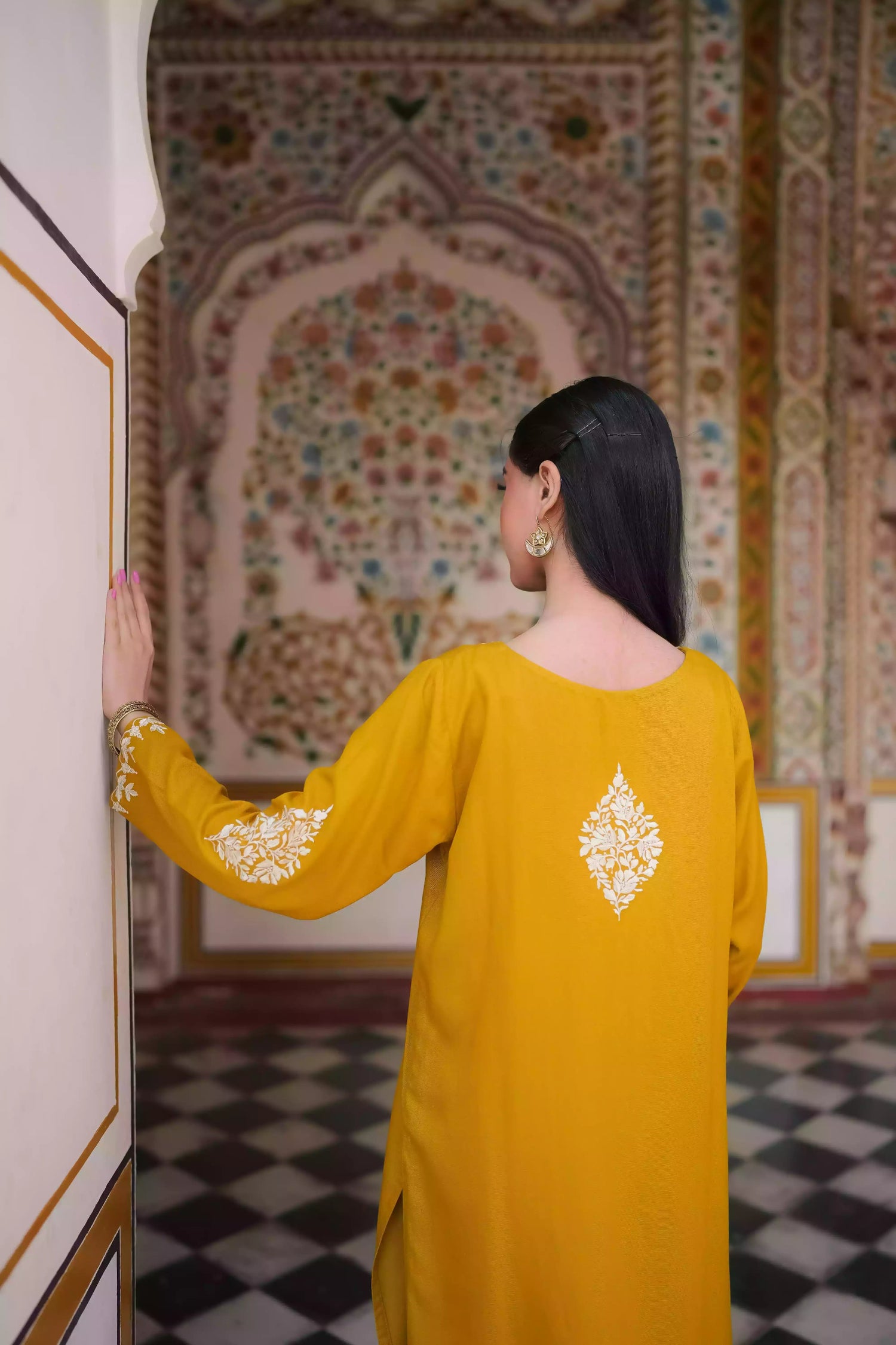 Mustard yellow embroidered kurta, featuring soft, flowing fabric with delicate white floral embroidery paired with a shalwar detailed with subtle threadwork. Styled for modern, festive, or daytime wear.