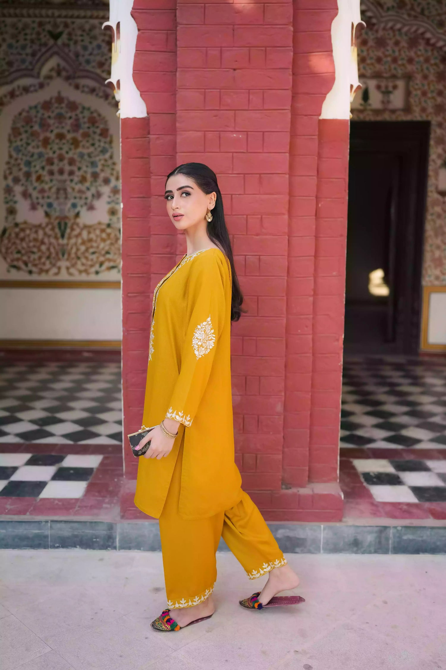 Mustard yellow embroidered kurta, featuring soft, flowing fabric with delicate white floral embroidery paired with a shalwar detailed with subtle threadwork. Styled for modern, festive, or daytime wear.
