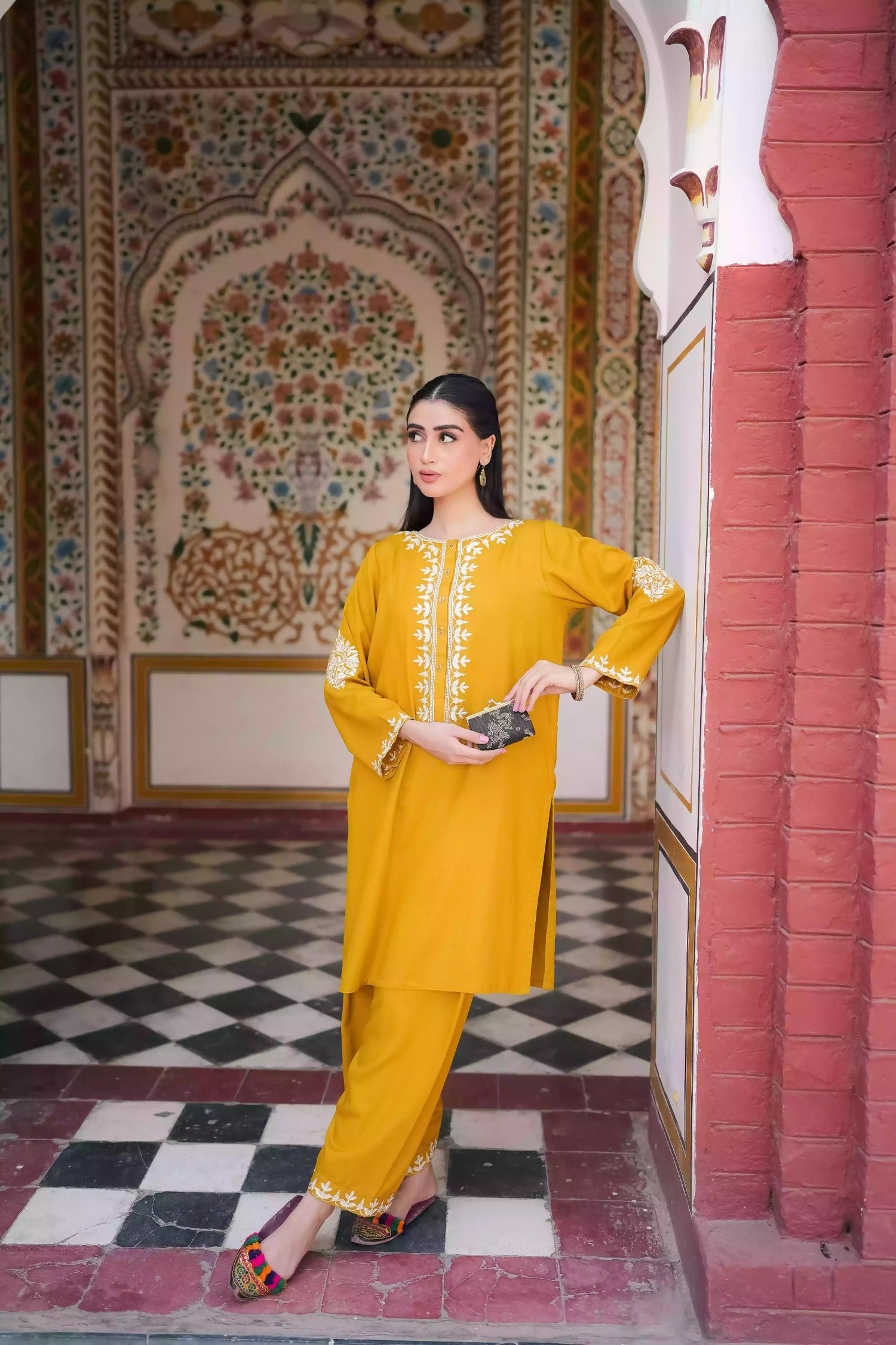 Mustard yellow embroidered kurta, featuring soft, flowing fabric with delicate white floral embroidery paired with a shalwar detailed with subtle threadwork. Styled for modern, festive, or daytime wear.