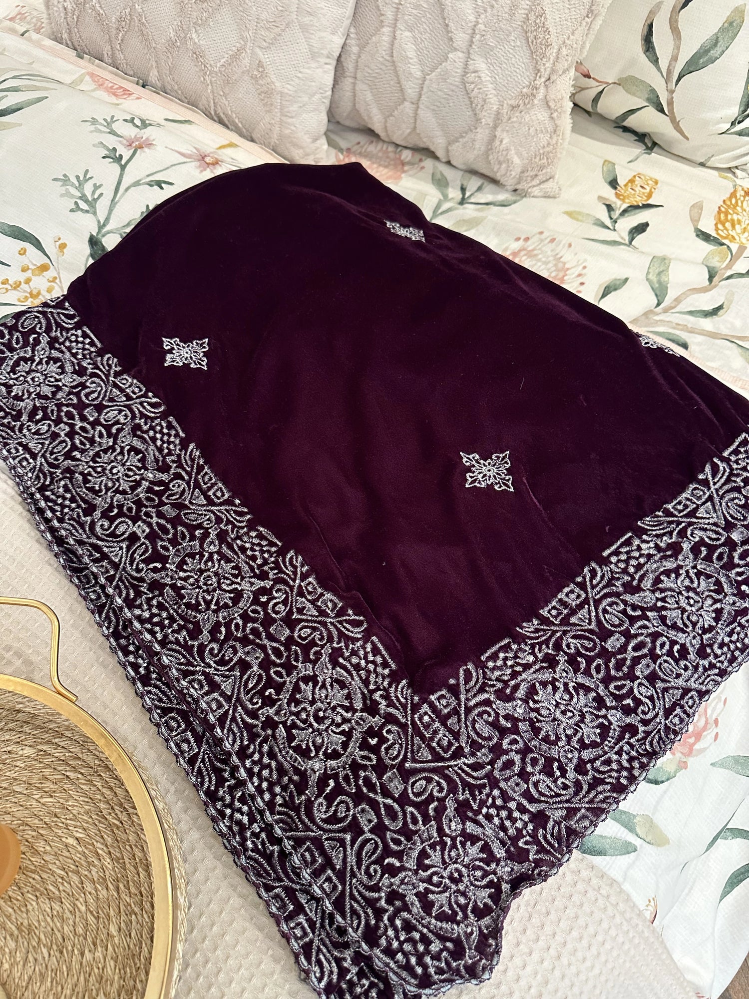 Rich deep plum velvet shawl with a smooth, lustrous finish, detailed with elaborate silver tilla embroidery. The shawl features a bold ornamental border of floral motifs across the body and finished with graceful border edges, making it a refined choice for formal occasions.