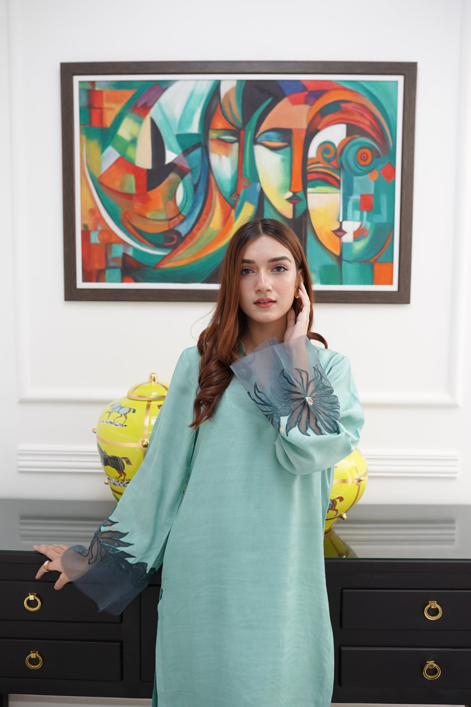 Mint green dress with contrasting green organza sleeves featuring intricate cutwork floral embroidery, blending soft elegance with nature-inspired design.