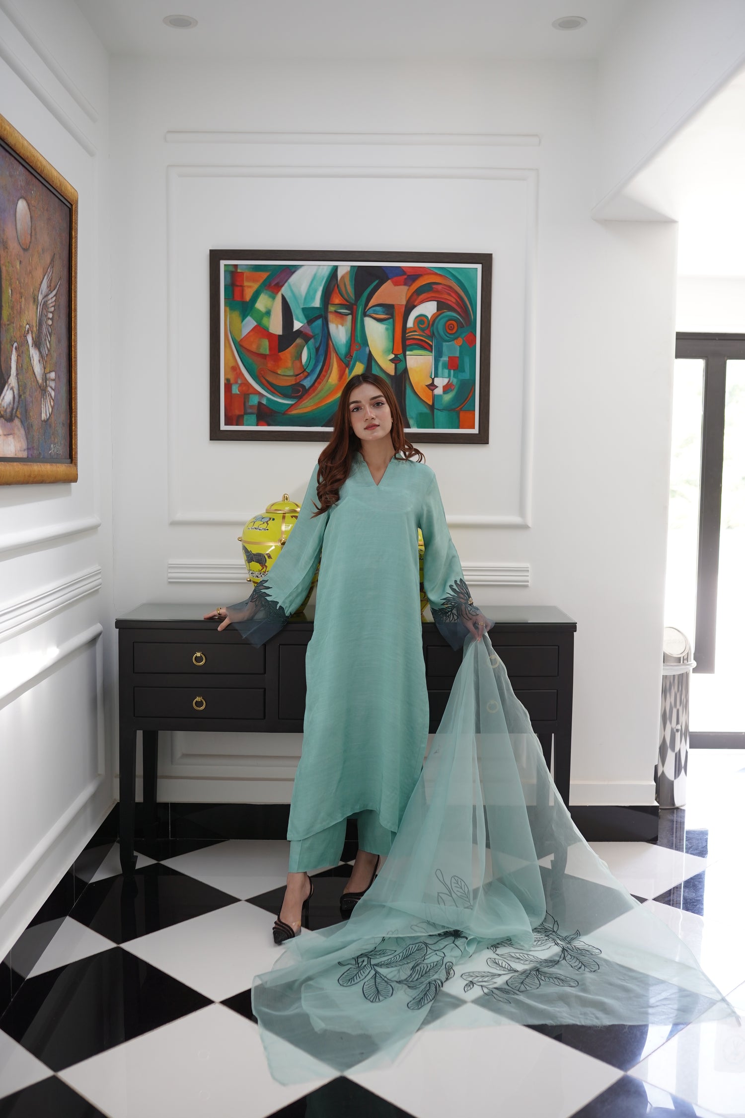 Mint green dress with contrasting green organza sleeves featuring intricate cutwork floral embroidery, blending soft elegance with nature-inspired design.