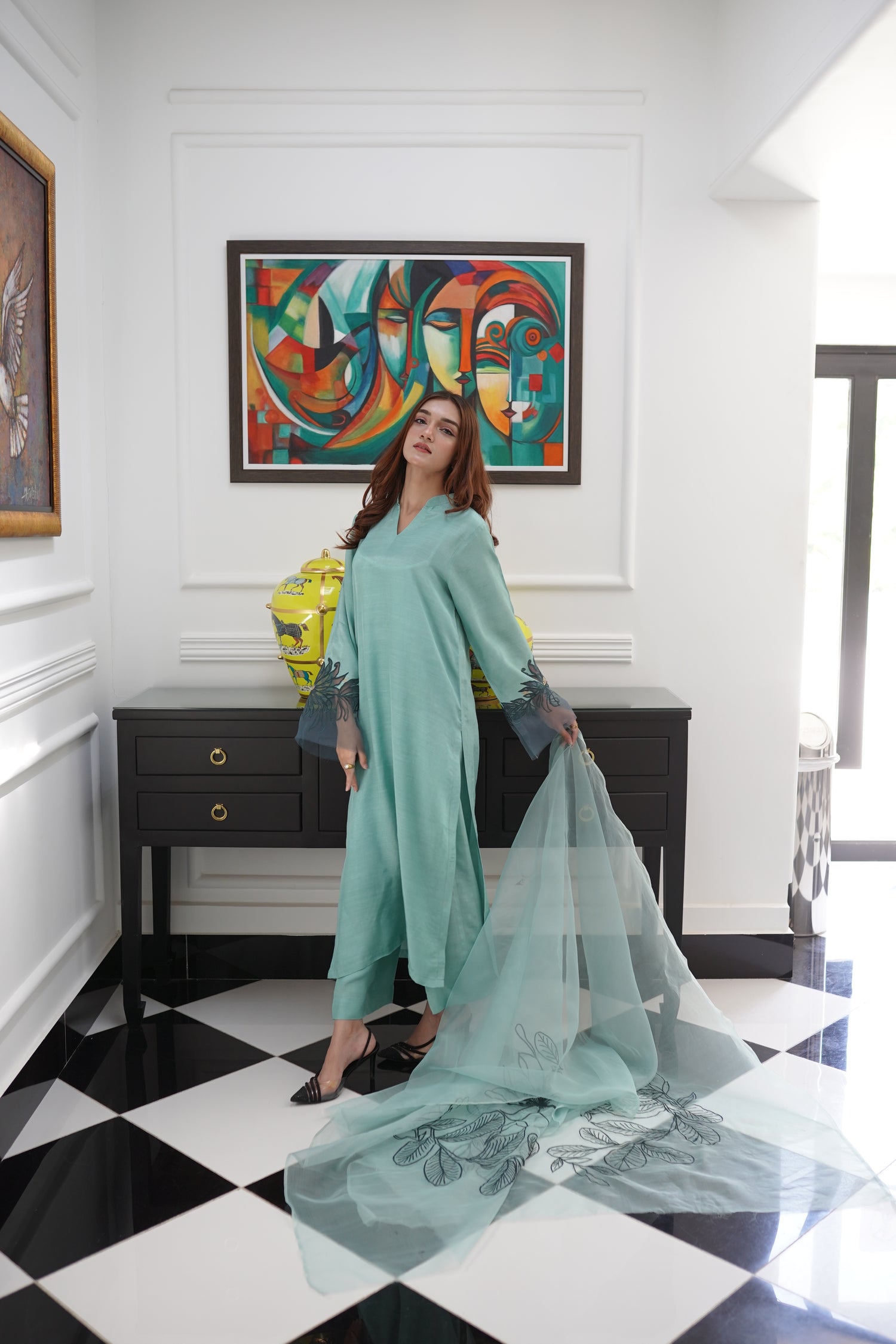 Mint green dress with contrasting green organza sleeves featuring intricate cutwork floral embroidery, blending soft elegance with nature-inspired design.