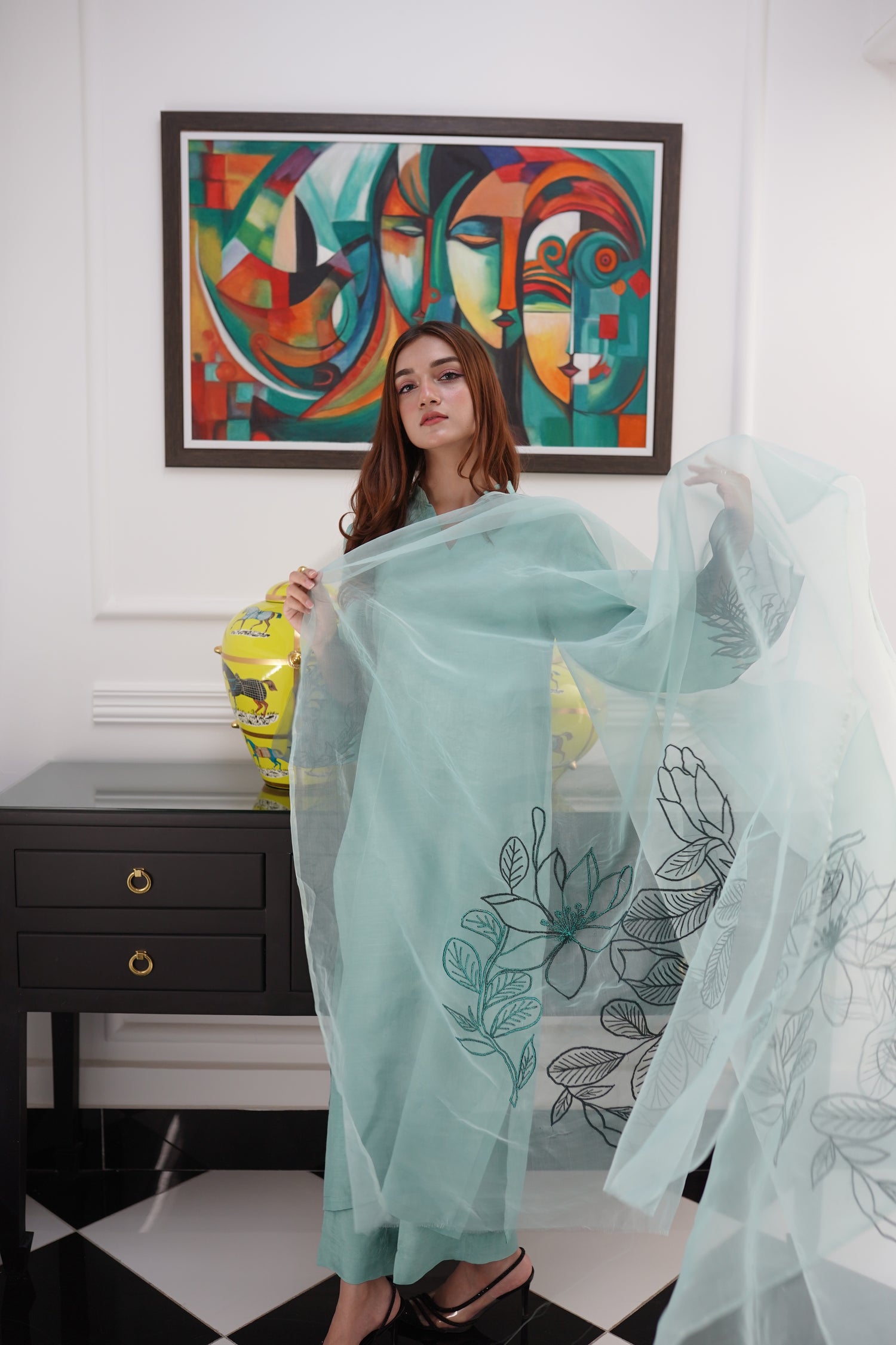 Mint green dress with contrasting green organza sleeves featuring intricate cutwork floral embroidery, blending soft elegance with nature-inspired design.