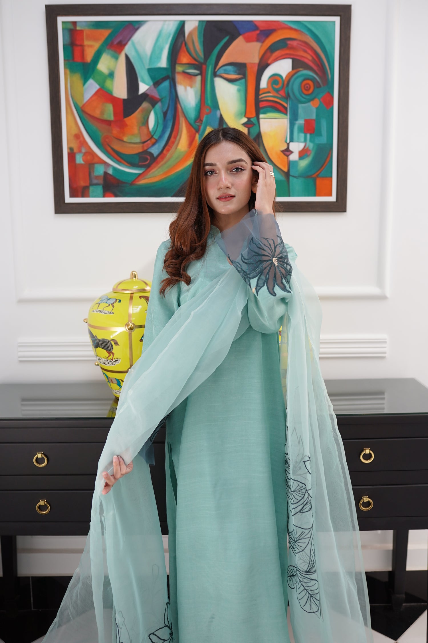 Mint green dress with contrasting green organza sleeves featuring intricate cutwork floral embroidery, blending soft elegance with nature-inspired design.