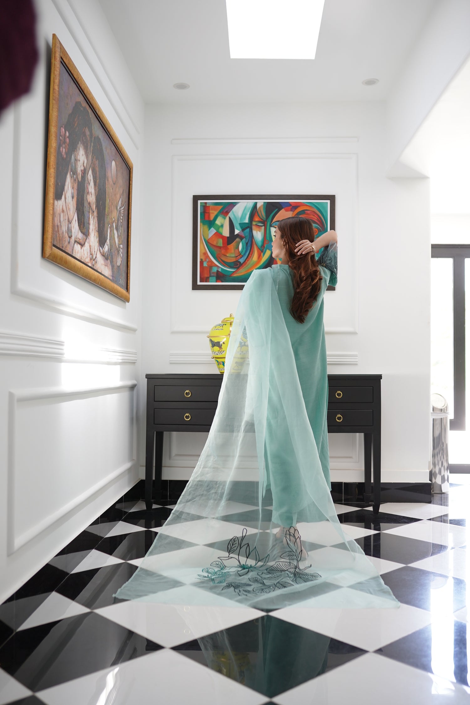 Mint green dress with contrasting green organza sleeves featuring intricate cutwork floral embroidery, blending soft elegance with nature-inspired design.