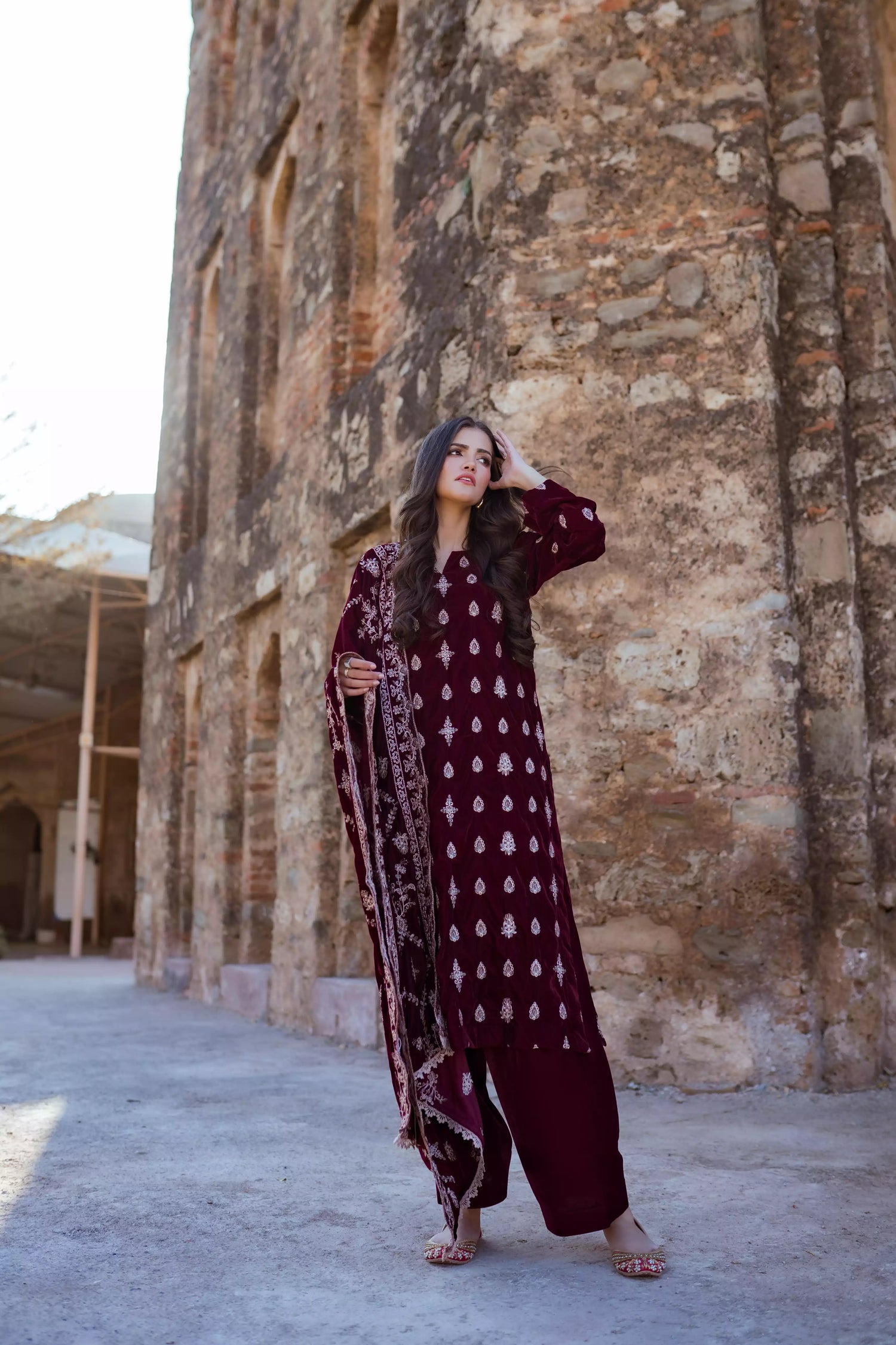 Traditional maroon velvet suit with embroidered details, complemented by a full embroidered shawl and chore paincha shalwar.