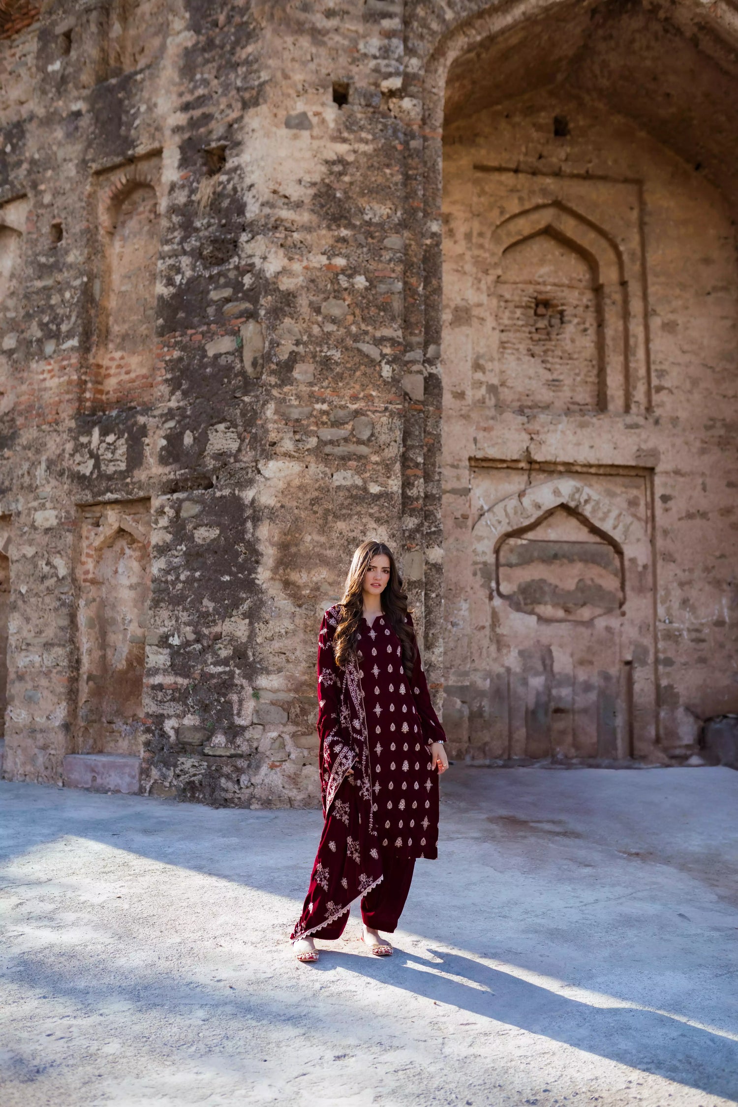 Traditional maroon velvet suit with embroidered details, complemented by a full embroidered shawl and chore paincha shalwar.