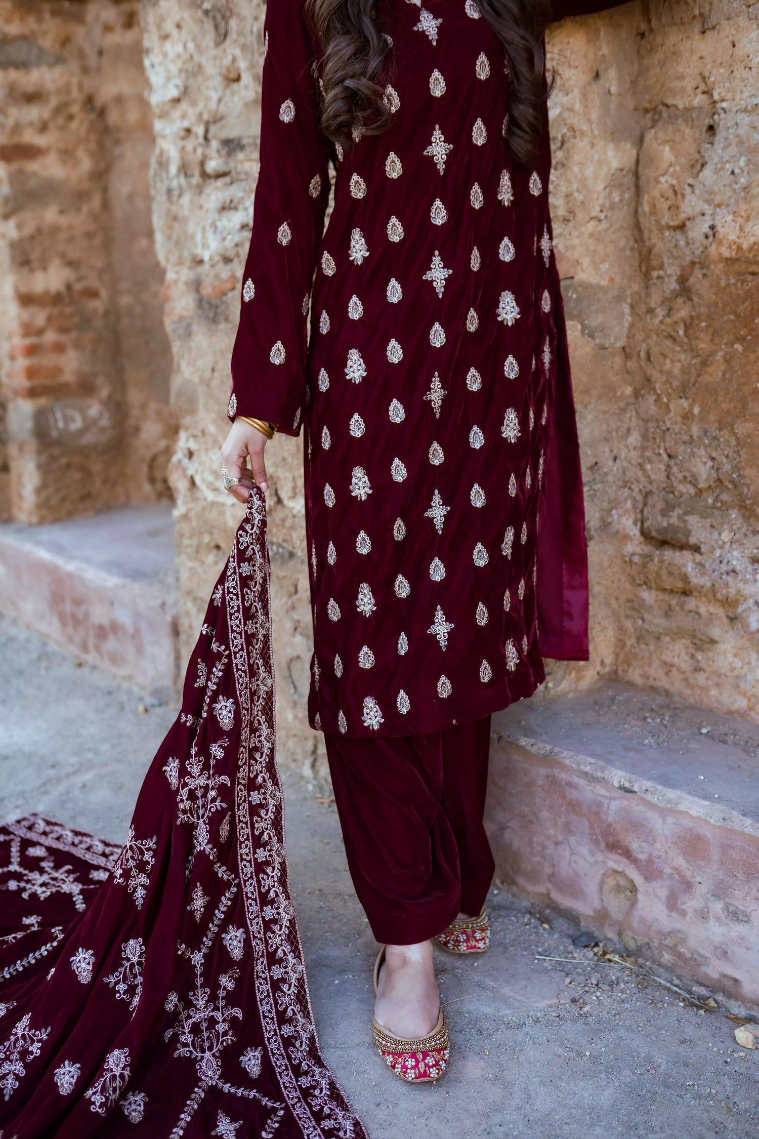 Traditional maroon velvet suit with embroidered details, complemented by a full embroidered shawl and chore paincha shalwar.