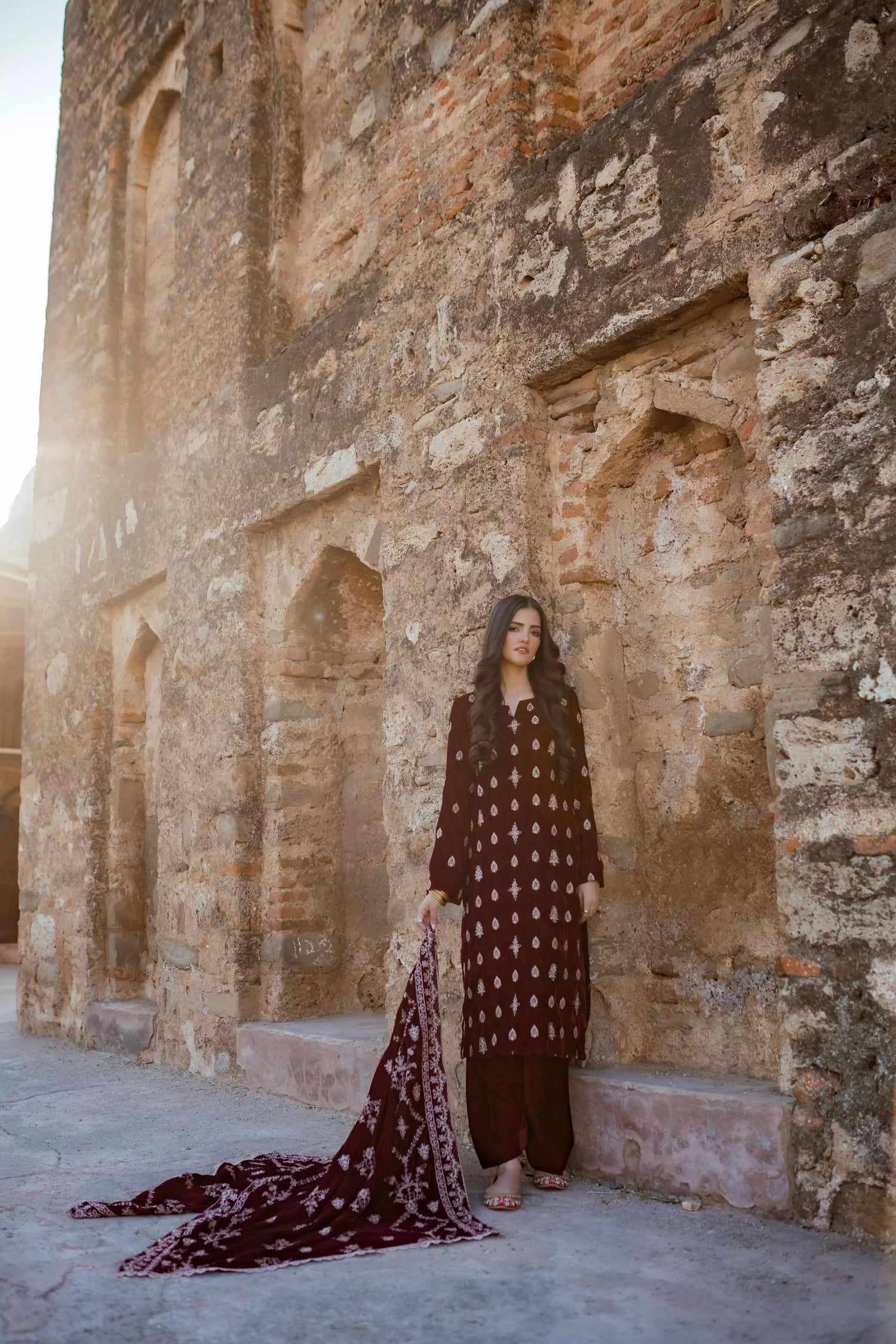 Traditional maroon velvet suit with embroidered details, complemented by a full embroidered shawl and chore paincha shalwar.