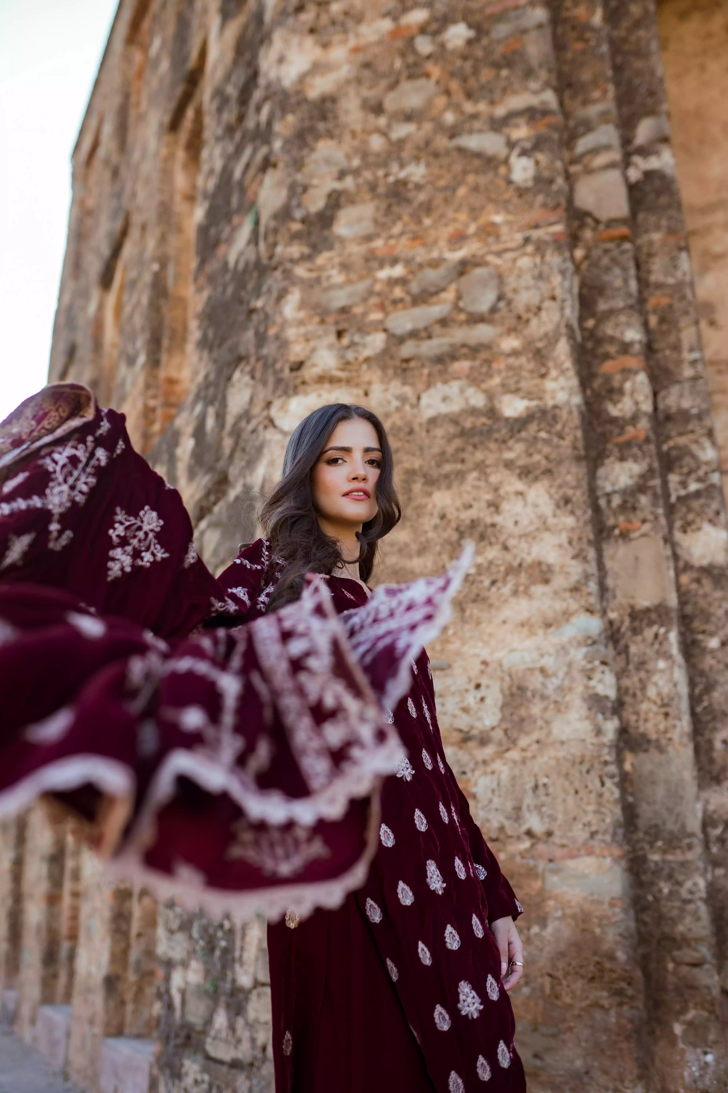 Traditional maroon velvet suit with embroidered details, complemented by a full embroidered shawl and chore paincha shalwar.
