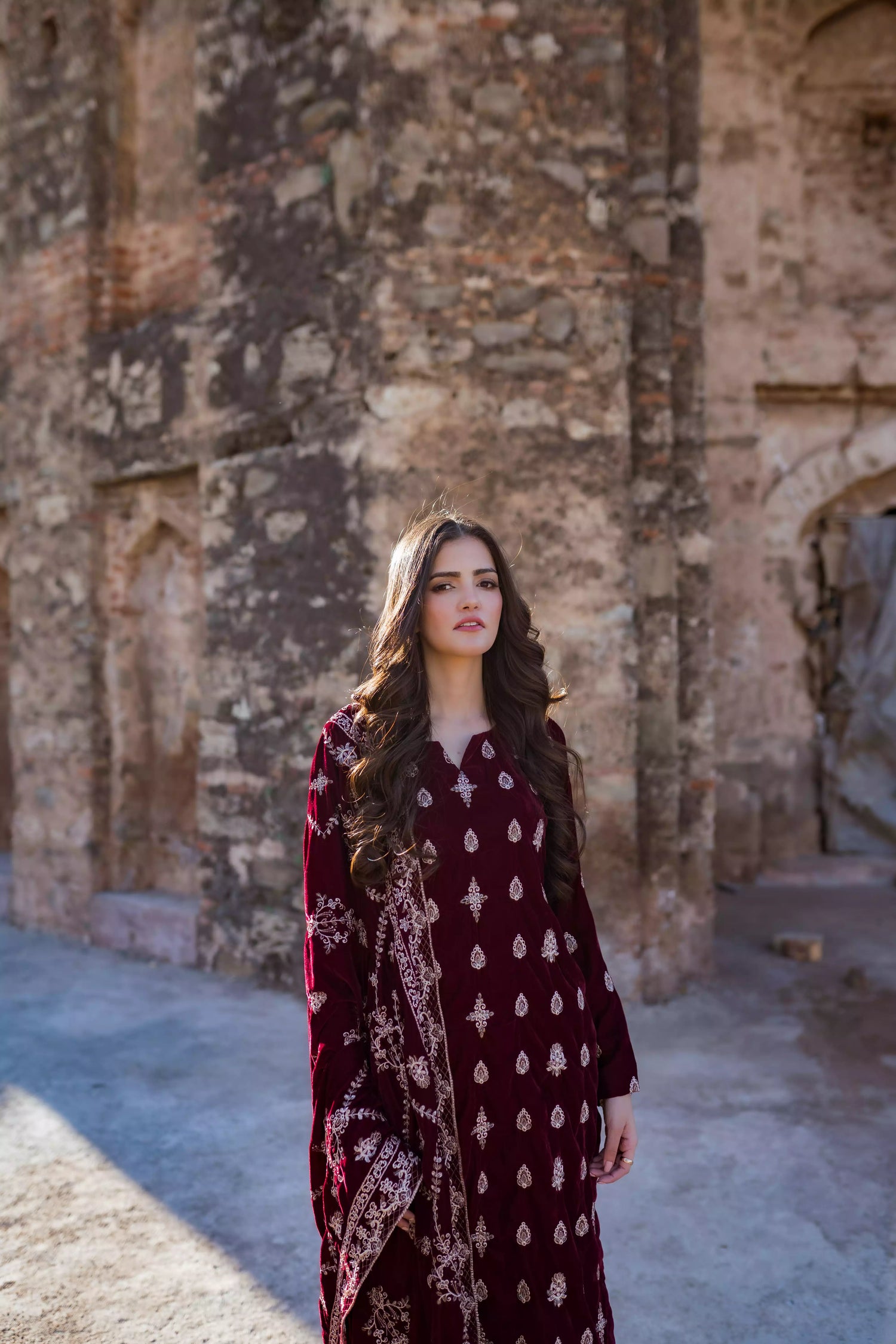 Traditional maroon velvet suit with embroidered details, complemented by a full embroidered shawl and chore paincha shalwar.