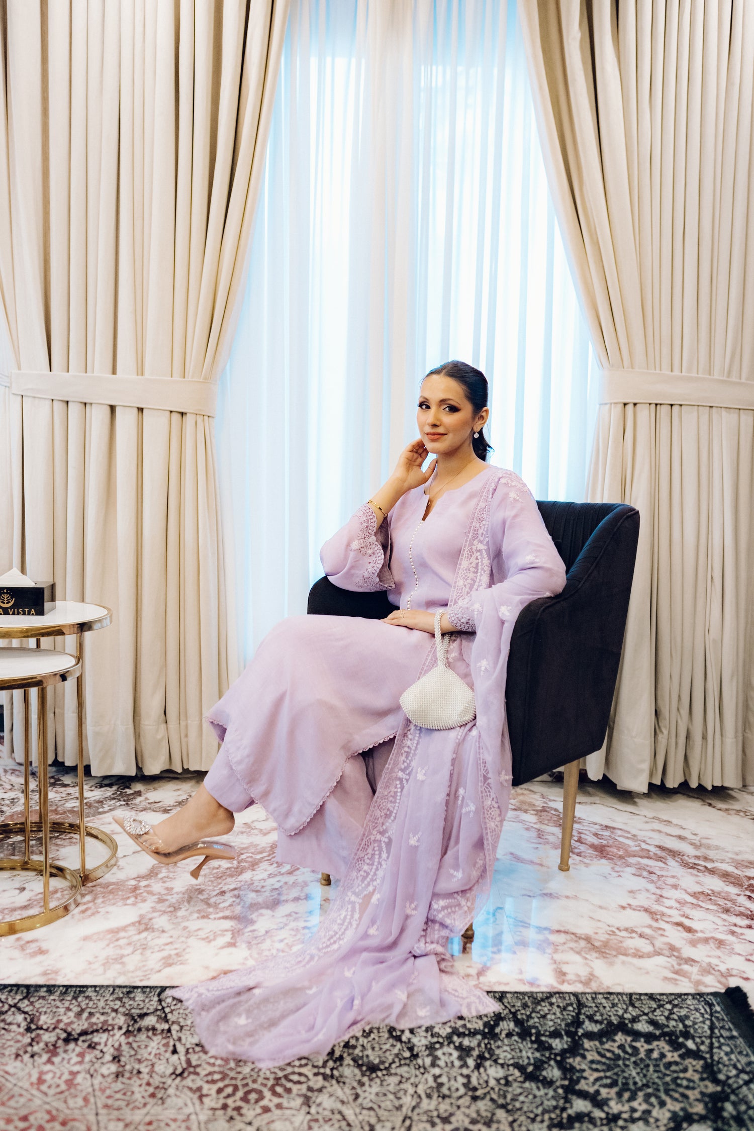 Lilac long shirt with pearl-buttoned neckline, lace-detailed hem, and embroidered sleeves, paired with a chiffon dupatta featuring matching floral embroidery for ethereal look.