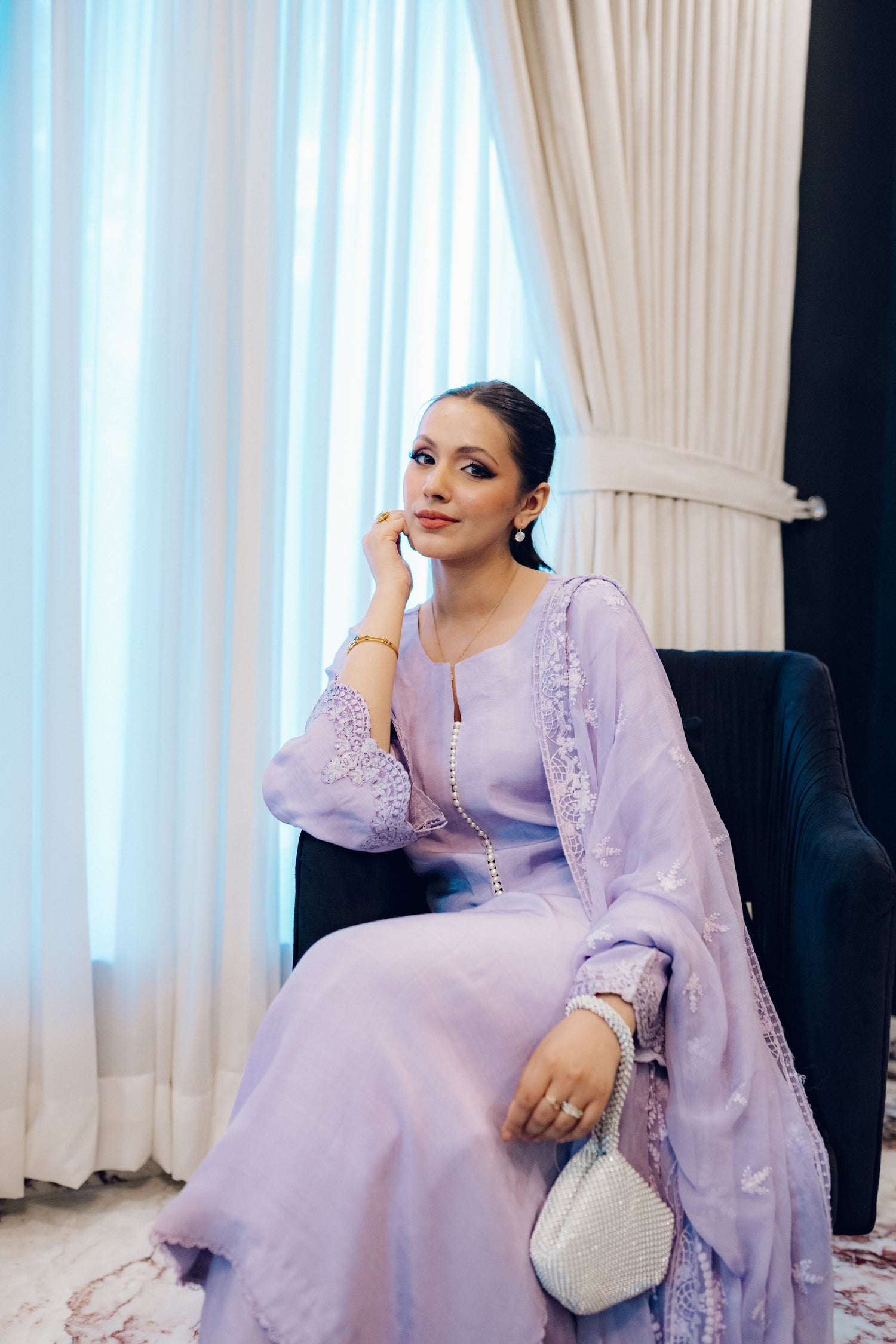 Lilac long shirt with pearl-buttoned neckline, lace-detailed hem, and embroidered sleeves, paired with a chiffon dupatta featuring matching floral embroidery for ethereal look.