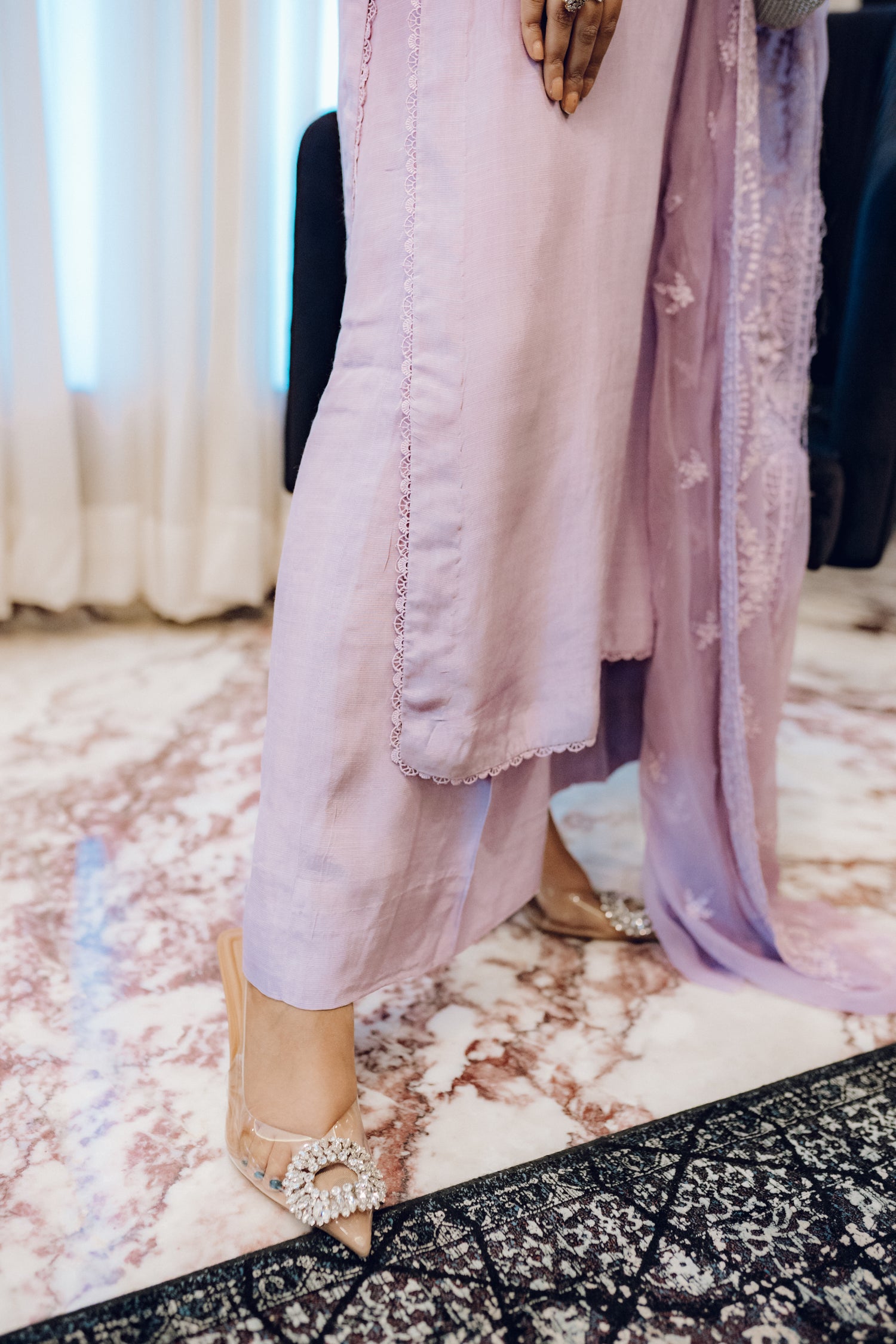 Lilac long shirt with pearl-buttoned neckline, lace-detailed hem, and embroidered sleeves, paired with a chiffon dupatta featuring matching floral embroidery for ethereal look.