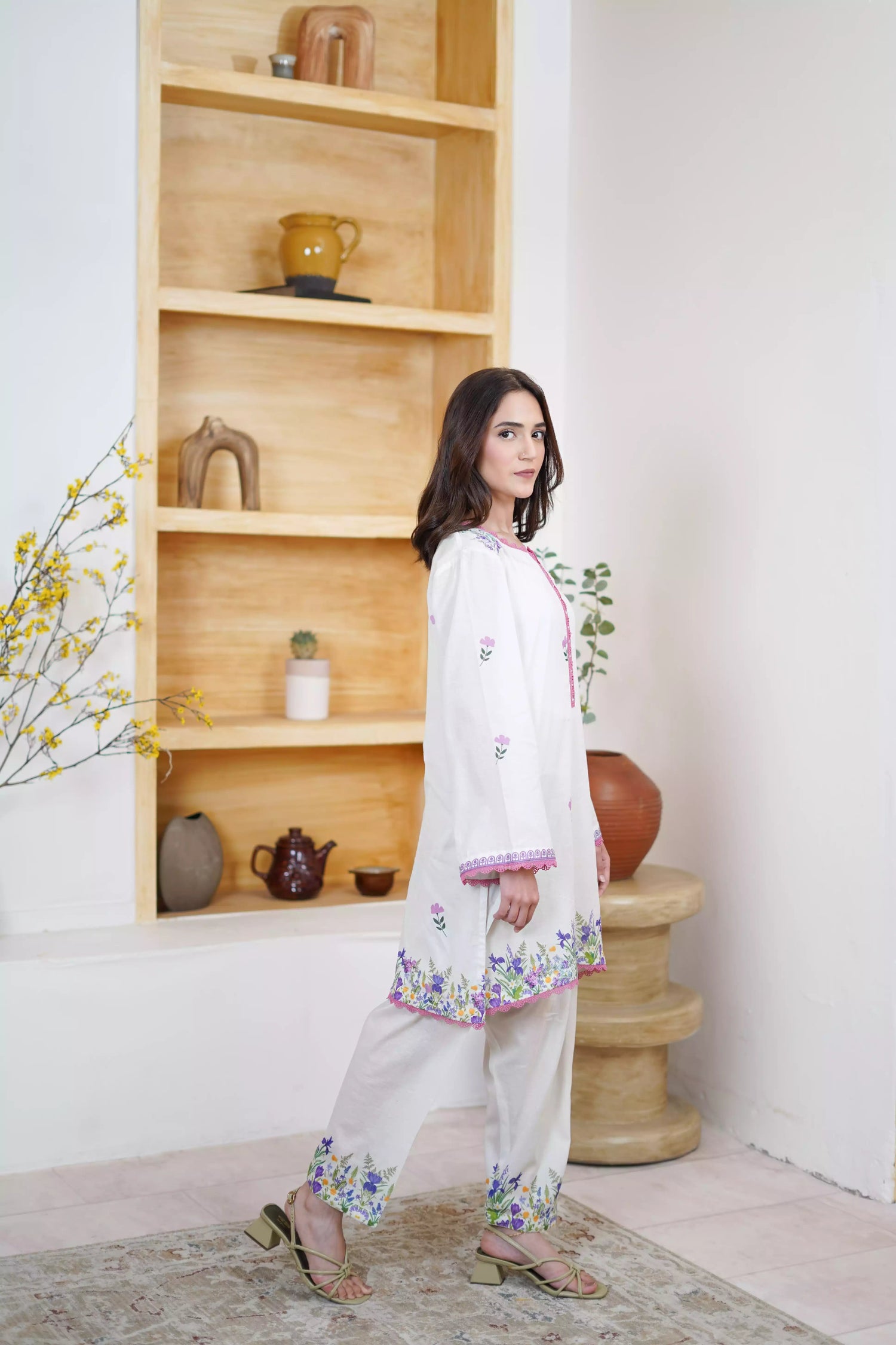 Cream Shalwar Kameez with delicate lavender and violet digital floral print, featuring scattered pastel blooms on breathable lawn. A graceful blend of modern charm.