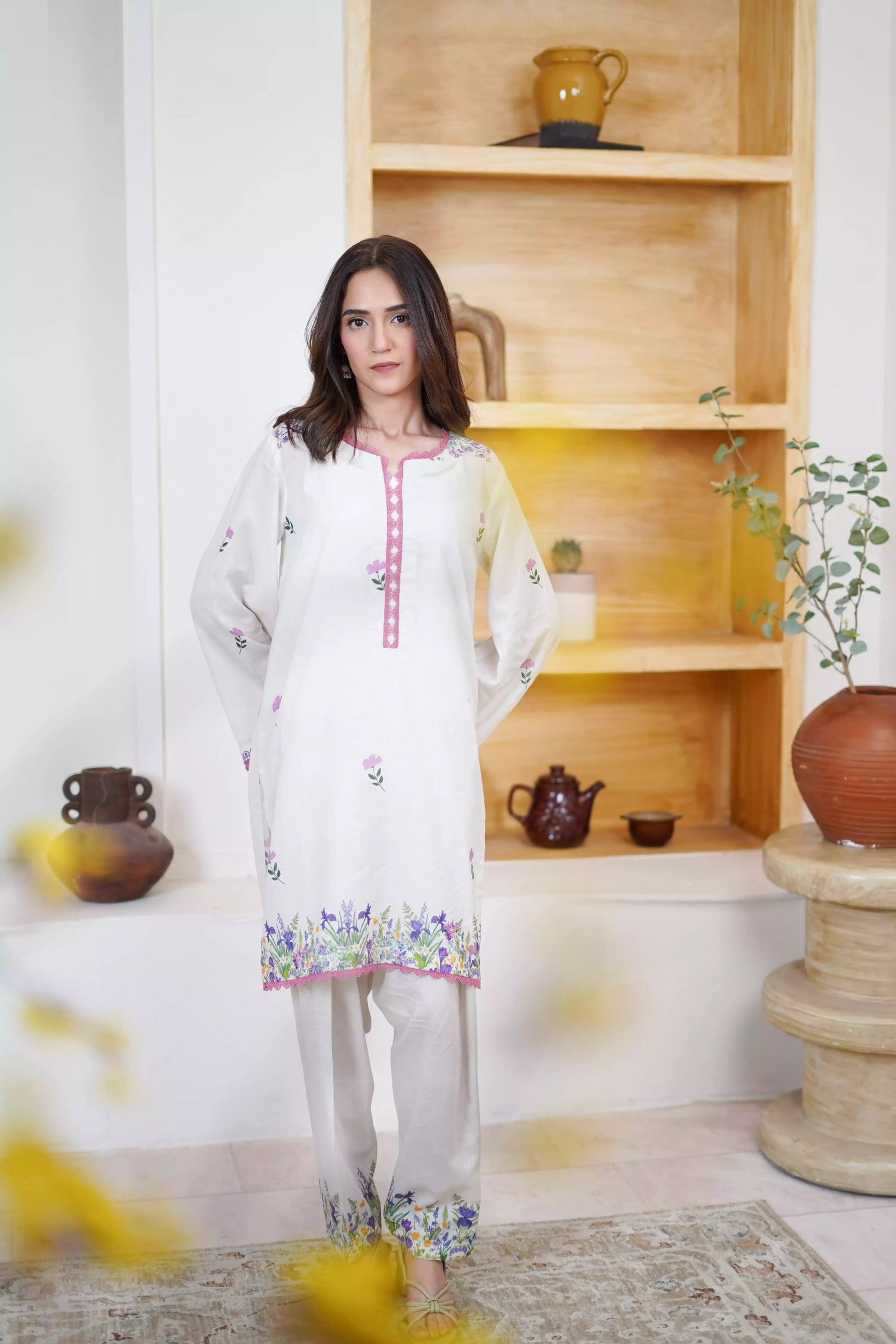 Cream Shalwar Kameez with delicate lavender and violet digital floral print, featuring scattered pastel blooms on breathable lawn. A graceful blend of modern charm.