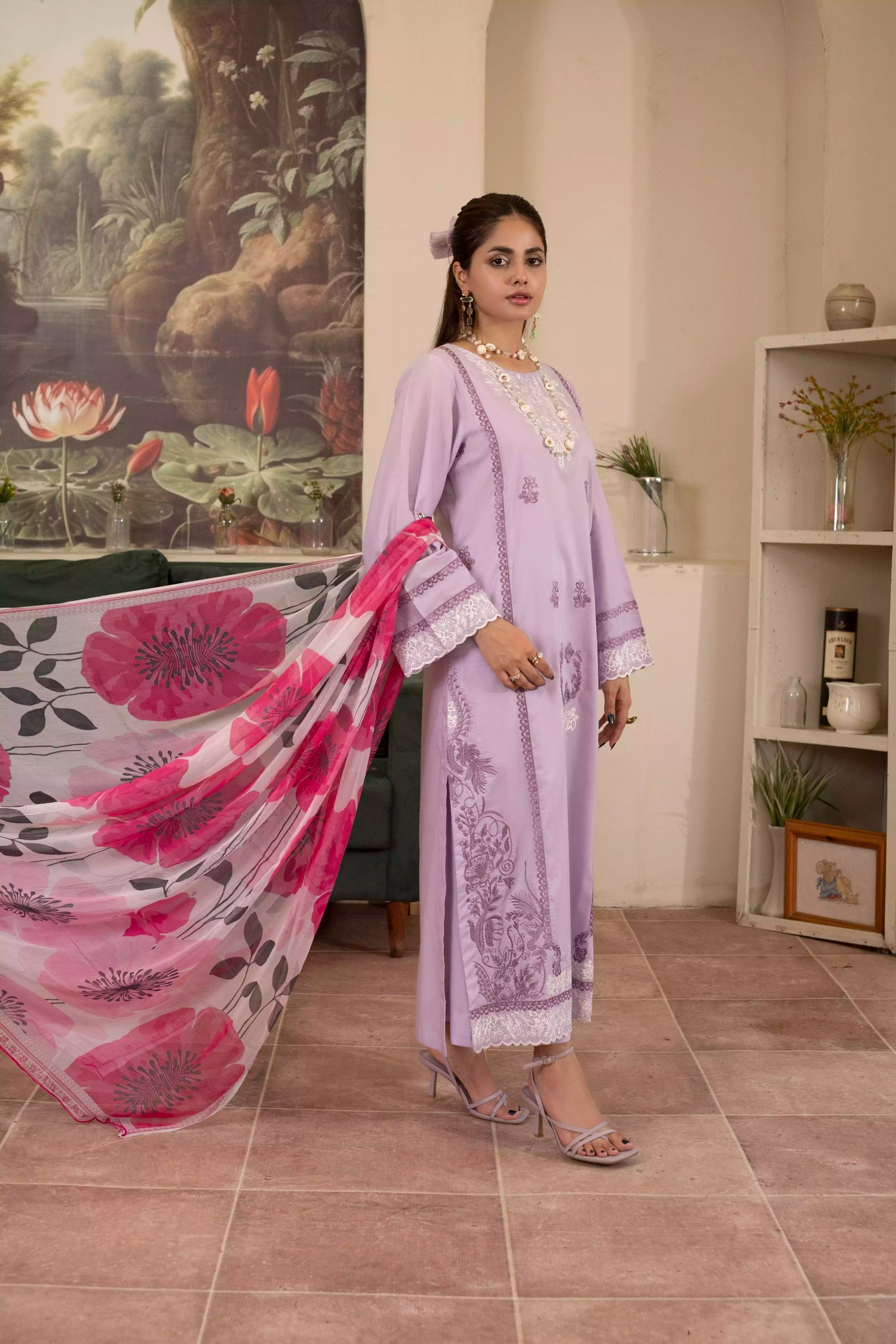 Elegant lilac suit with white embroidery, complemented by a pink rose-printed silk dupatta for a festive look.